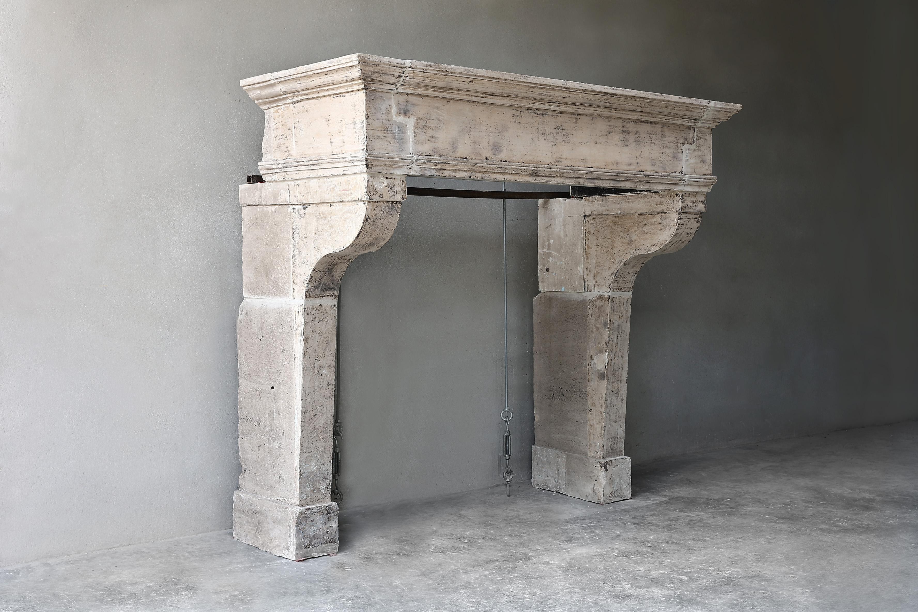Beautiful rustic castle fireplace of French limestone from the 19th century in the style of Campagnarde. This fireplace has a wide front part and beautiful stately legs. The format is not too wide for a castle fireplace, so this chimney fits in many