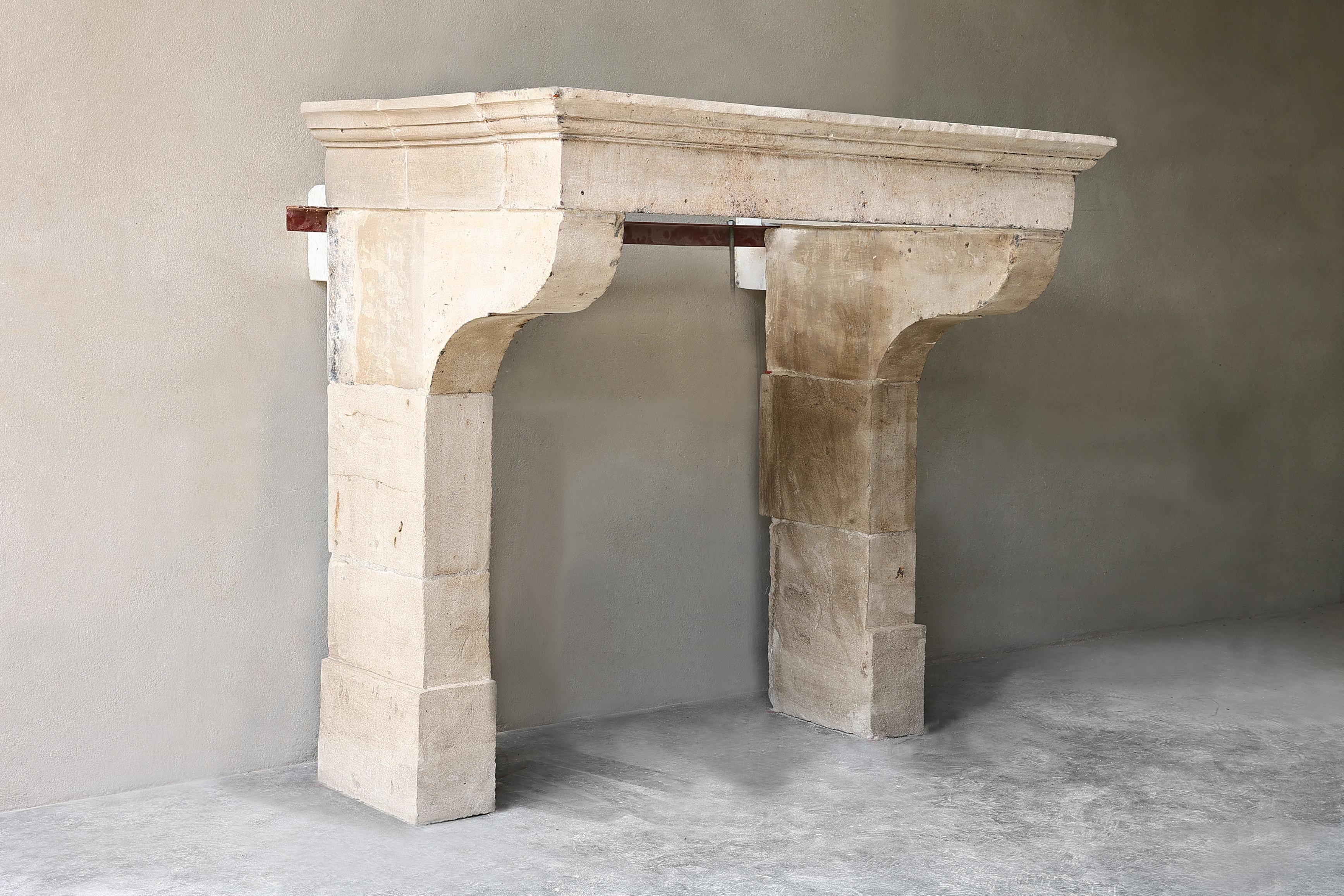 Beautiful antique fireplace because of its simplicity! An old French limestone mantle from the 19th century with a beautiful molding (lines), curved legs and elegant front part. A fireplace with accessible dimensions that can be used in many