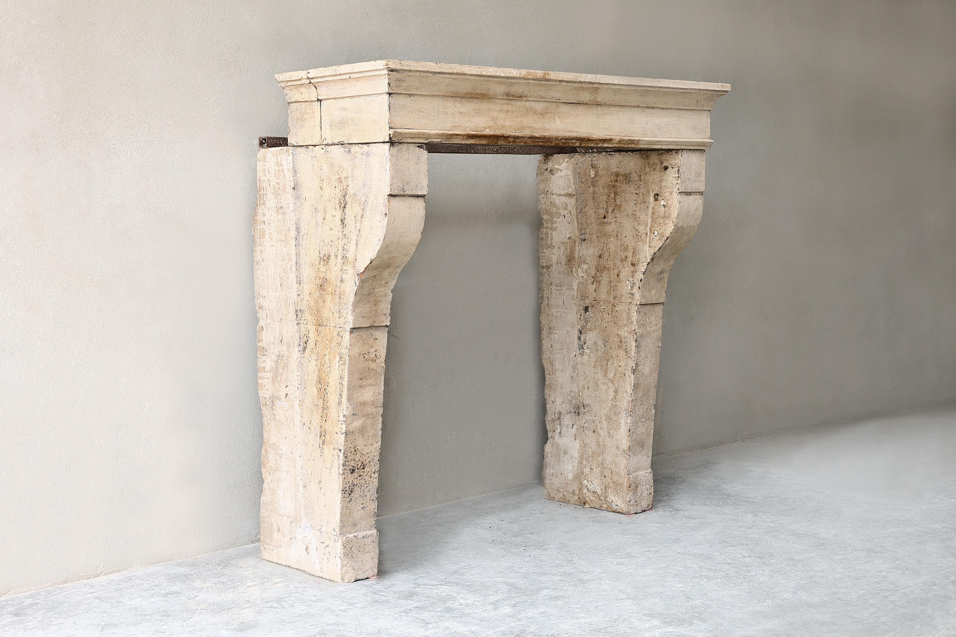 Rustic French limestone fireplace from the 19th century. This fireplace has beautiful lines and a rustic look. A fireplace that is extremely suitable for a living room, roof or outdoor area.