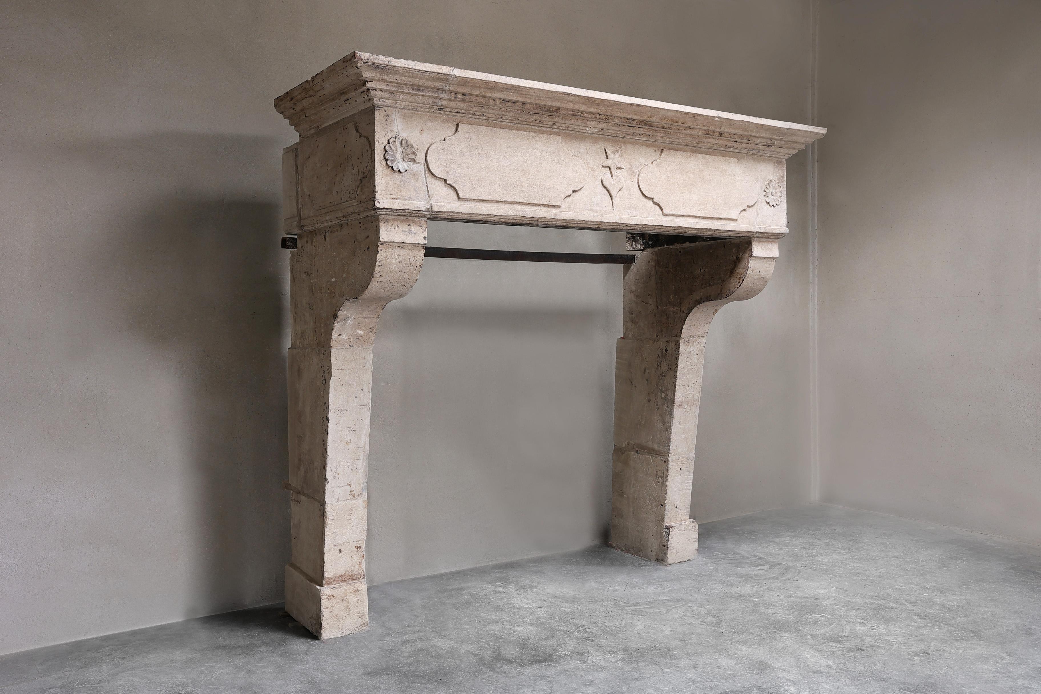 A beautiful robust castle mantelpiece made of French limestone in the style of Louis XIII and from the 19th century. This French mantelpiece has a beautifully decorated front section, but not too busy, with an authentic look!