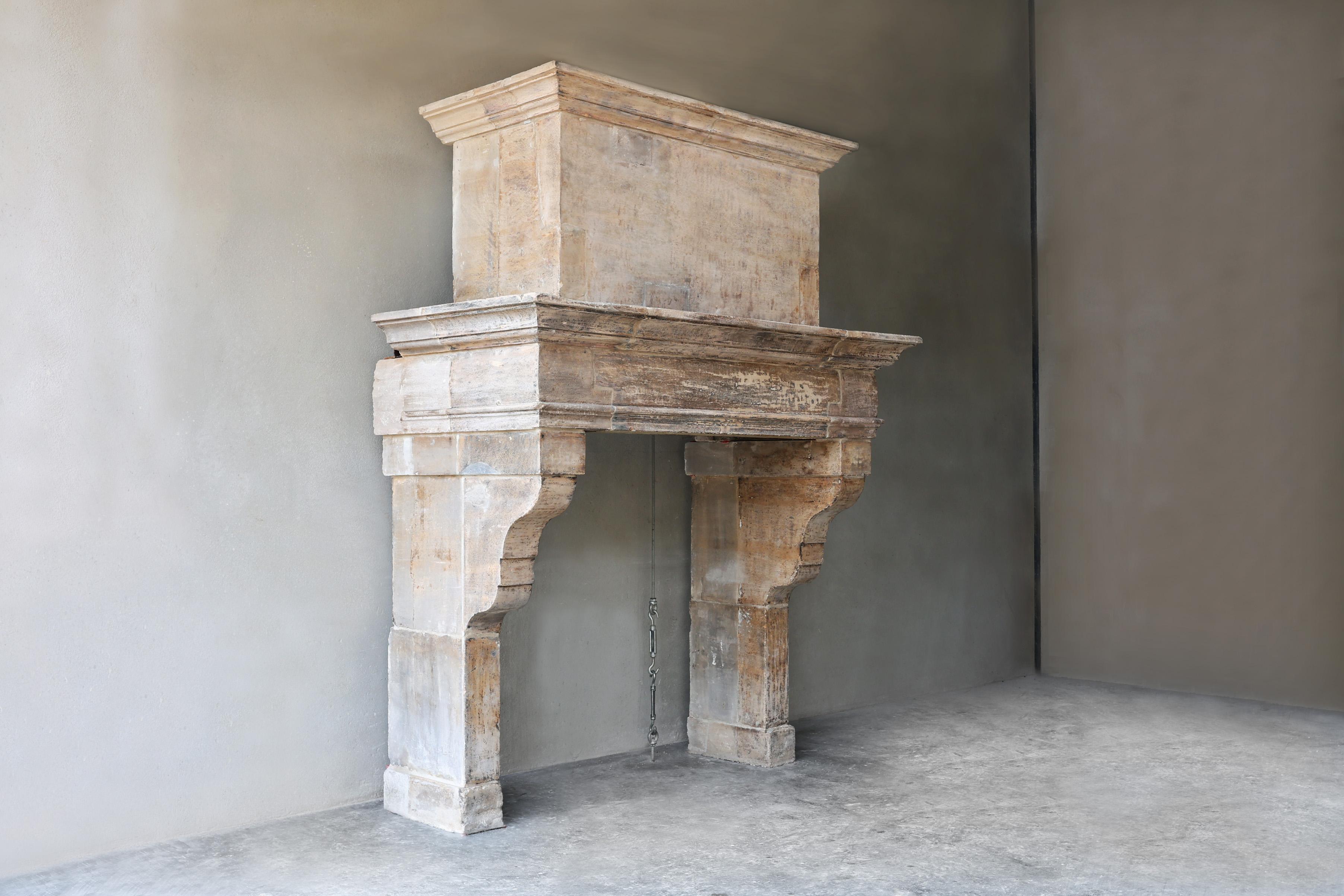 Imposing castle fireplace with French limestone trumeau from the 19th century! This stately fireplace has a rustic look and beautiful design! We call the upper part of the fireplace a trumeau and it gives extra allure to a chimney. This fireplace is