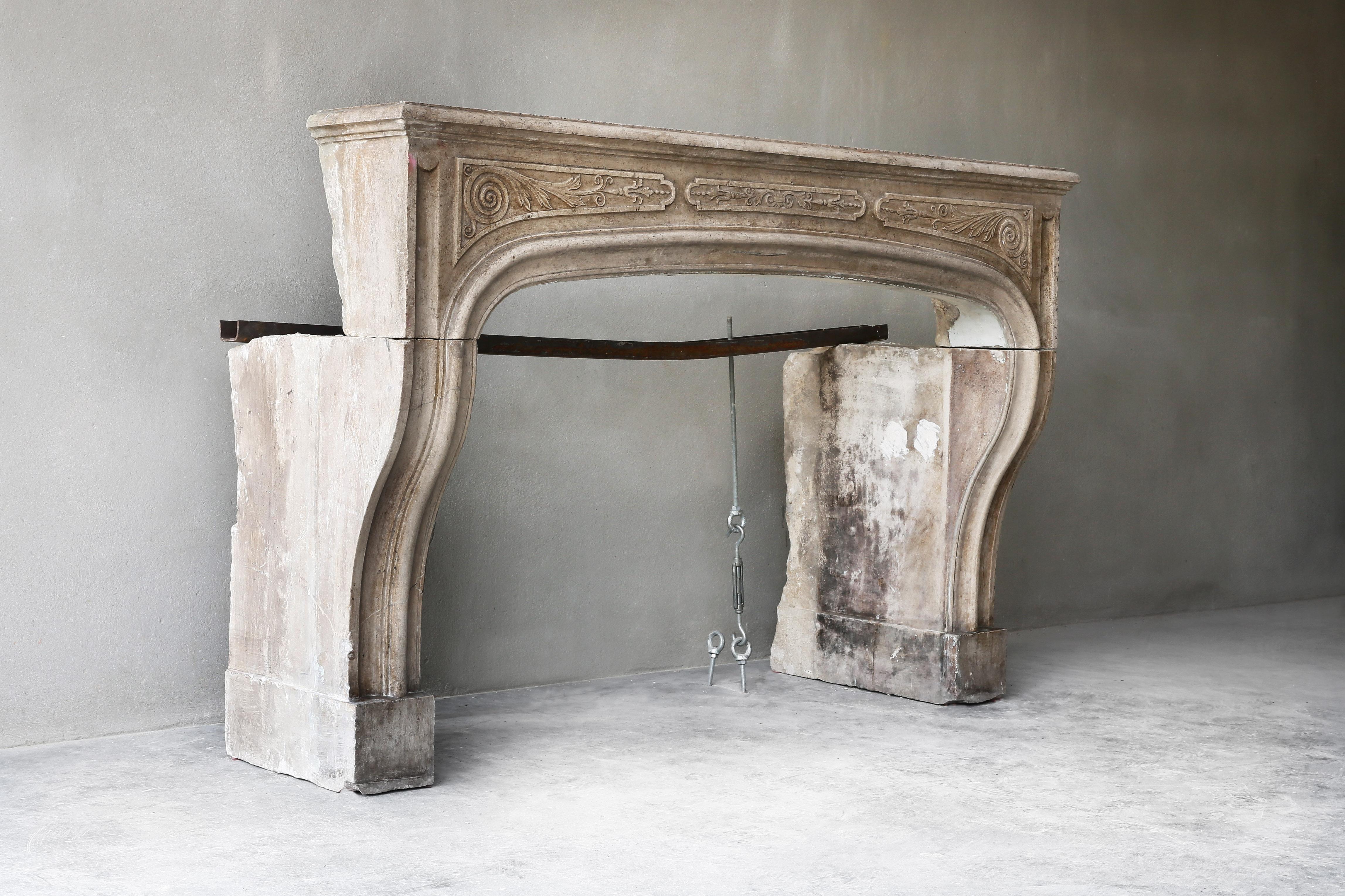 Beautiful elegant antique fireplace from the 19th century. A fireplace with character and history! The fireplace is richly decorated with various ornaments in the front section. The curves make the fireplace elegant and stylish. This fireplace is