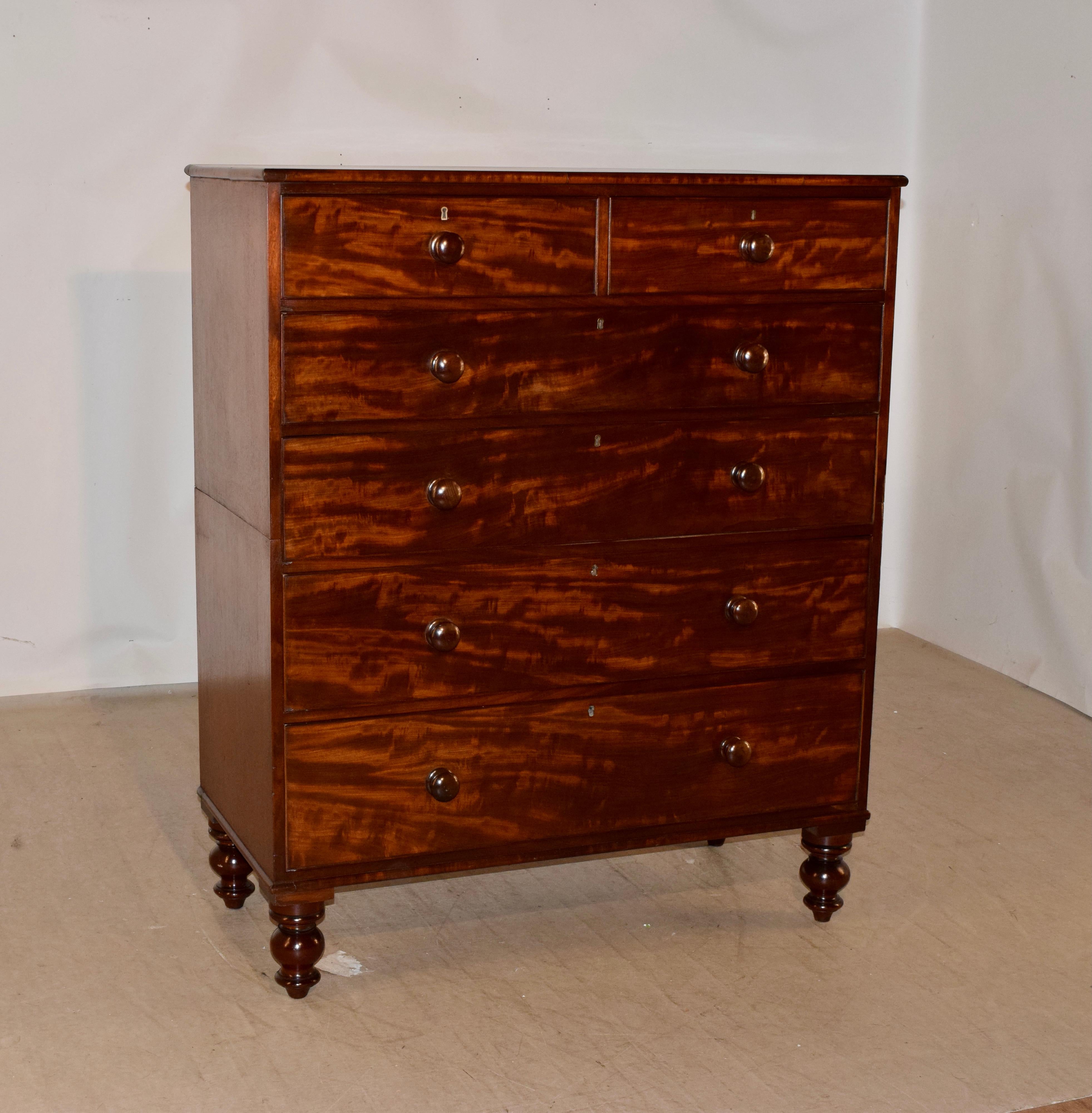 19th century flame mahogany chest of drawers from England. The top is made from a single plank and is wonderfully grained. This follows down to simple sides and two over four drawers in the front. The drawer fronts are also made from the beautifully