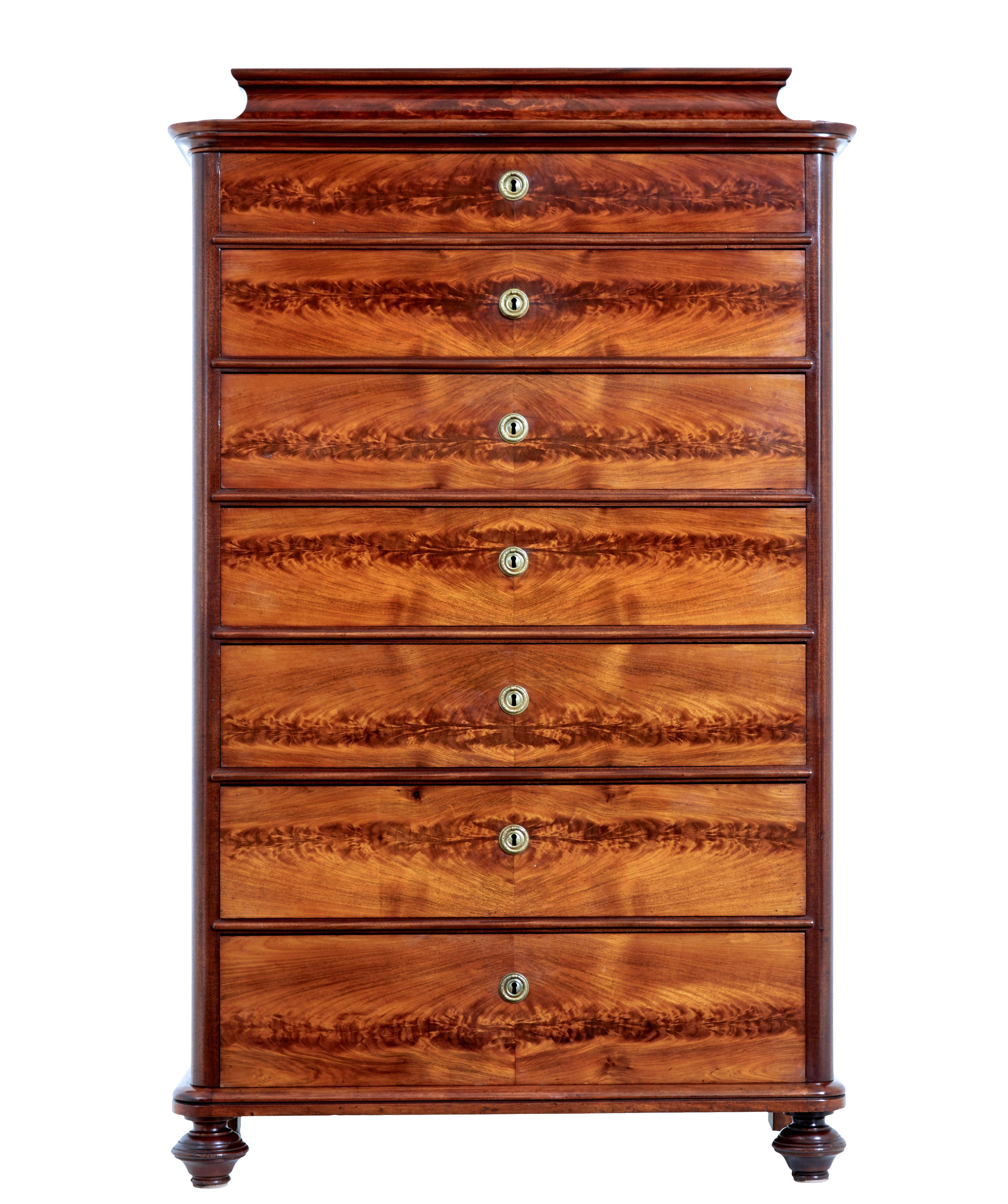 19th century flame mahogany tall chest of drawers circa 1870.

Fine quality caddy top tall chest of drawers, which is also known as a seminere chest, because of the use of 7 drawers.

Made using mahogany and flame mahogany veneers.  Caddy shaped top