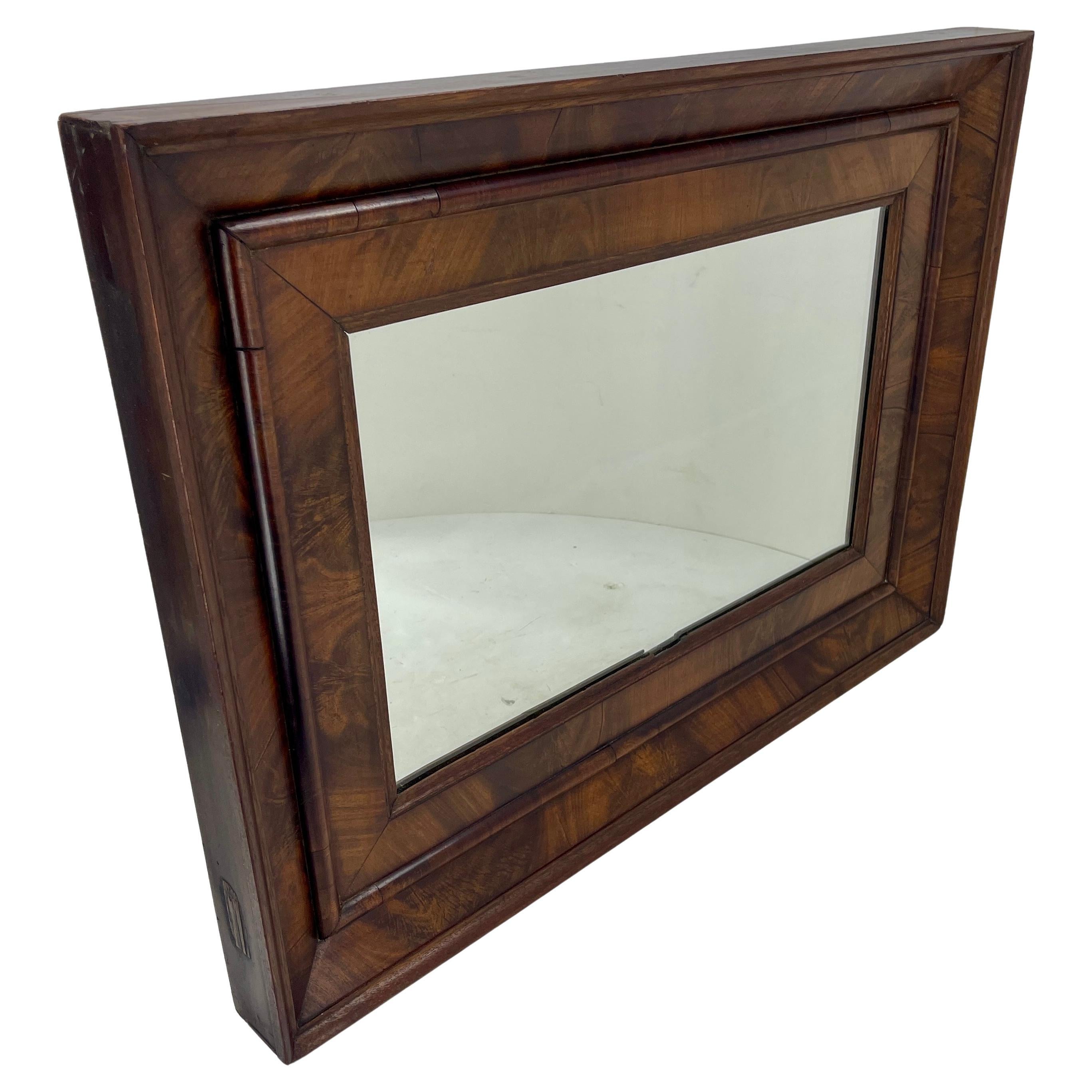 Antique American empire flame mahogany rectangular wall mirror.
This mirror will hang horizontally or vertically.
The Ogee mahogany veneered is a particular charm worth noting. This mirror presents itself as sturdy, heavy and charmingly radiant.