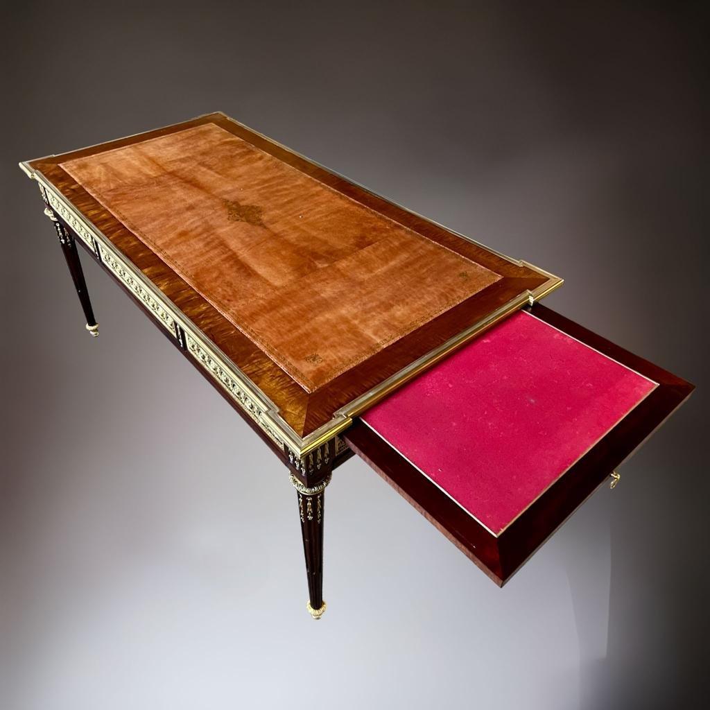 We present you this exceptional, large and opulent marquetry desk from the late 19th century. Crafted with exceptional skill by a Parisian cabinetmaker in Faubourg Saint Antoine, this desk is a prime example of Louis XVI-style furniture, made from