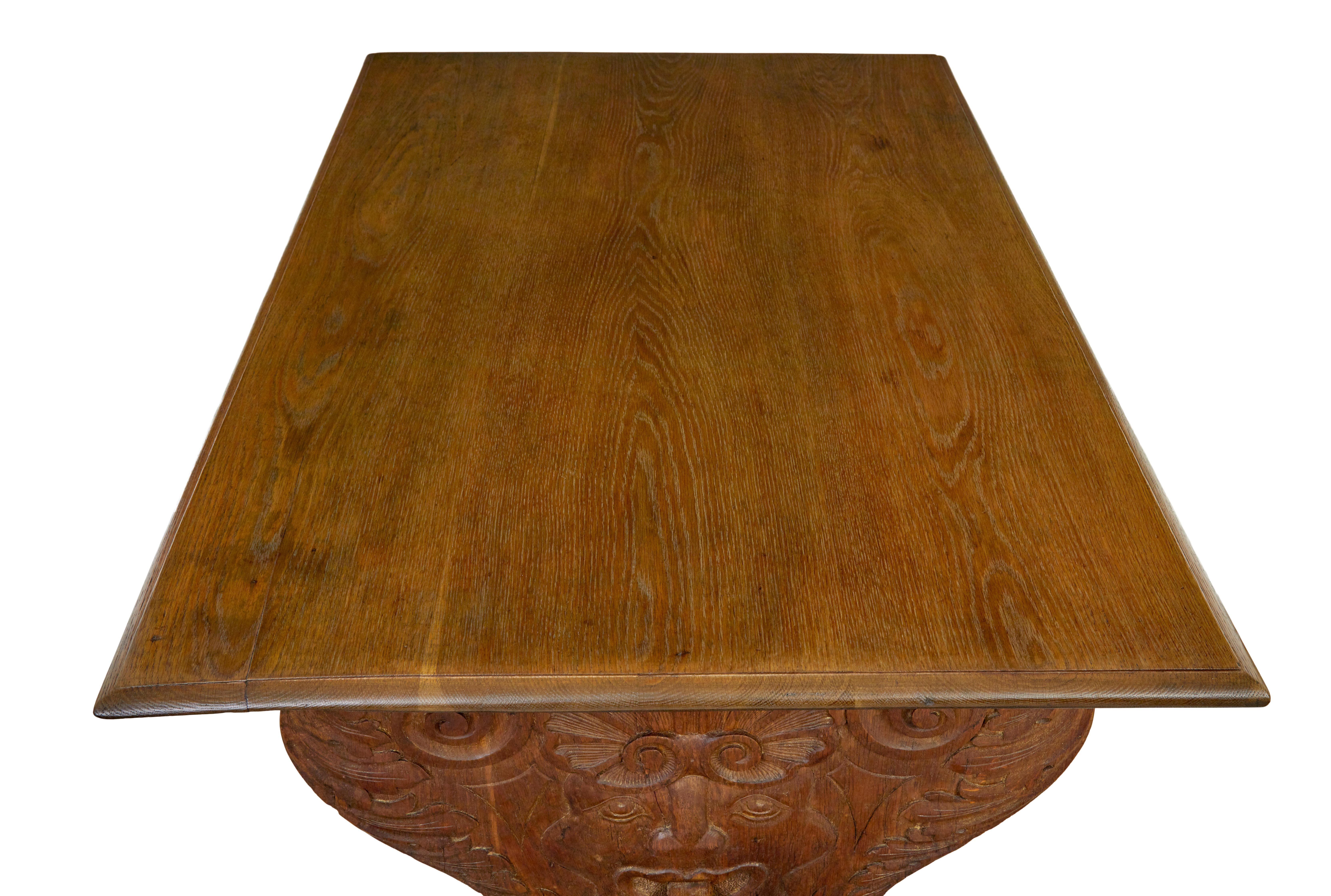 Carved 19th century Flemish carved oak green man dining table and benches