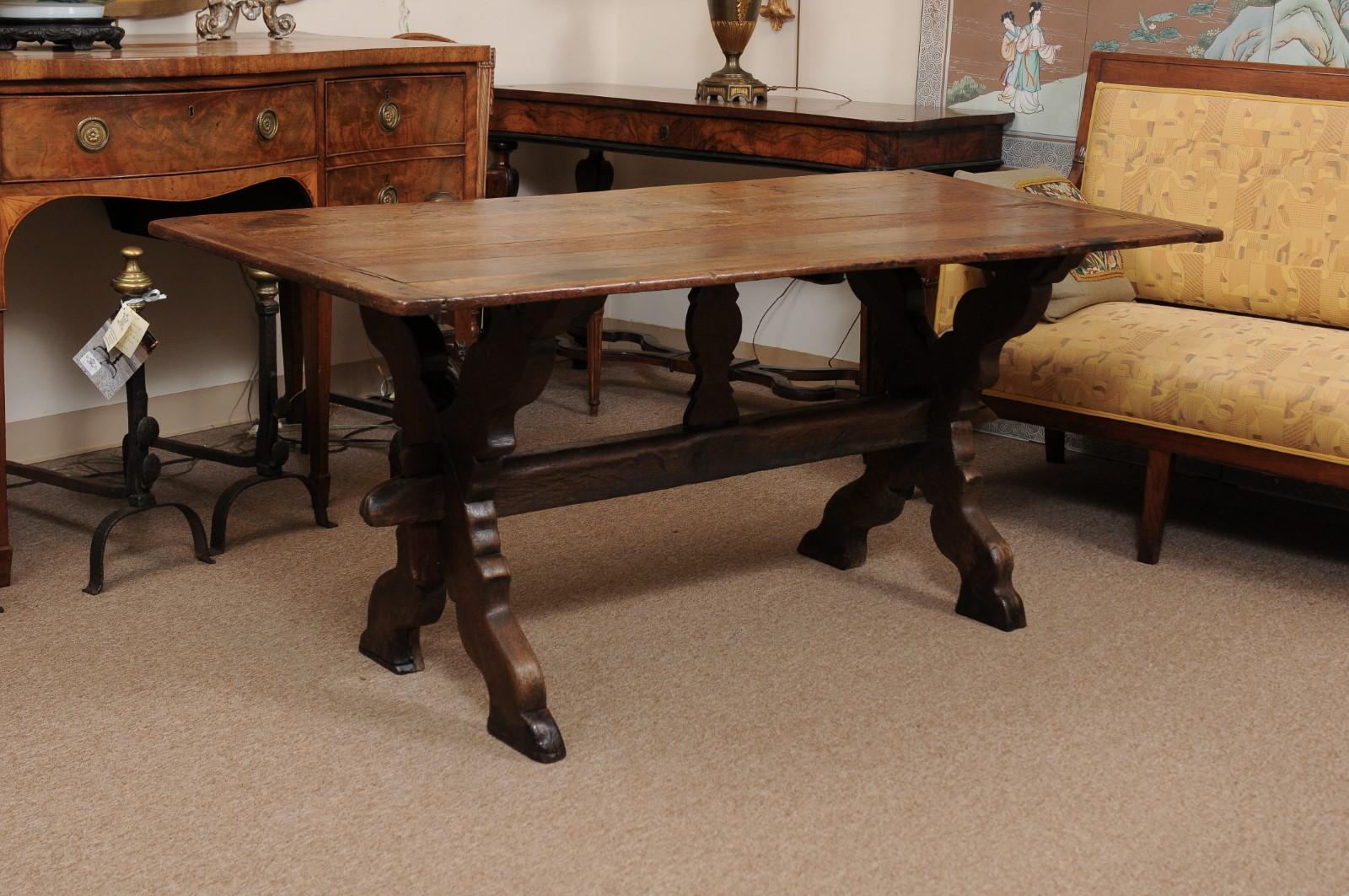 A 19th century Flemish oak trestle dining table with X-leg and stretcher.

 