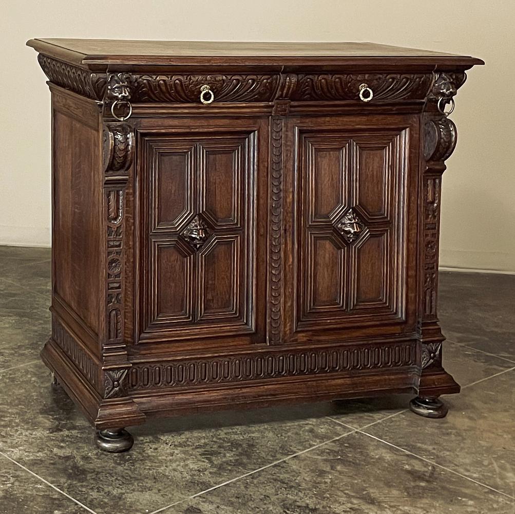 19th Century Flemish Renaissance Buffet was hand-crafted from solid oak, and features the unique molding designs of the region, creating a diamond shaped centerpiece on the cabinet doors into which a full relief carving of a lion's head has been