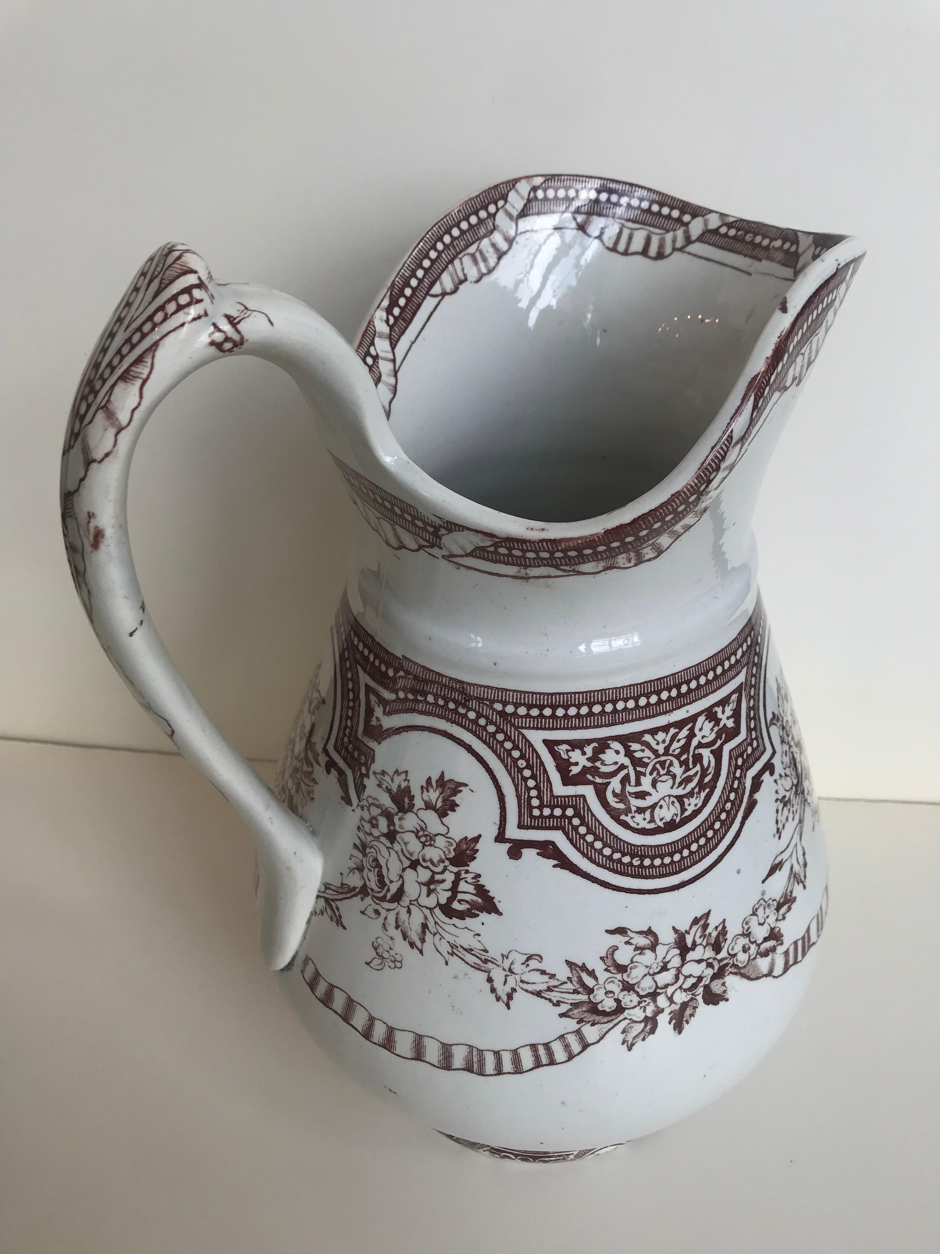 19th century English floral ribbon banded ironstone pitcher.
X marking on bottom.