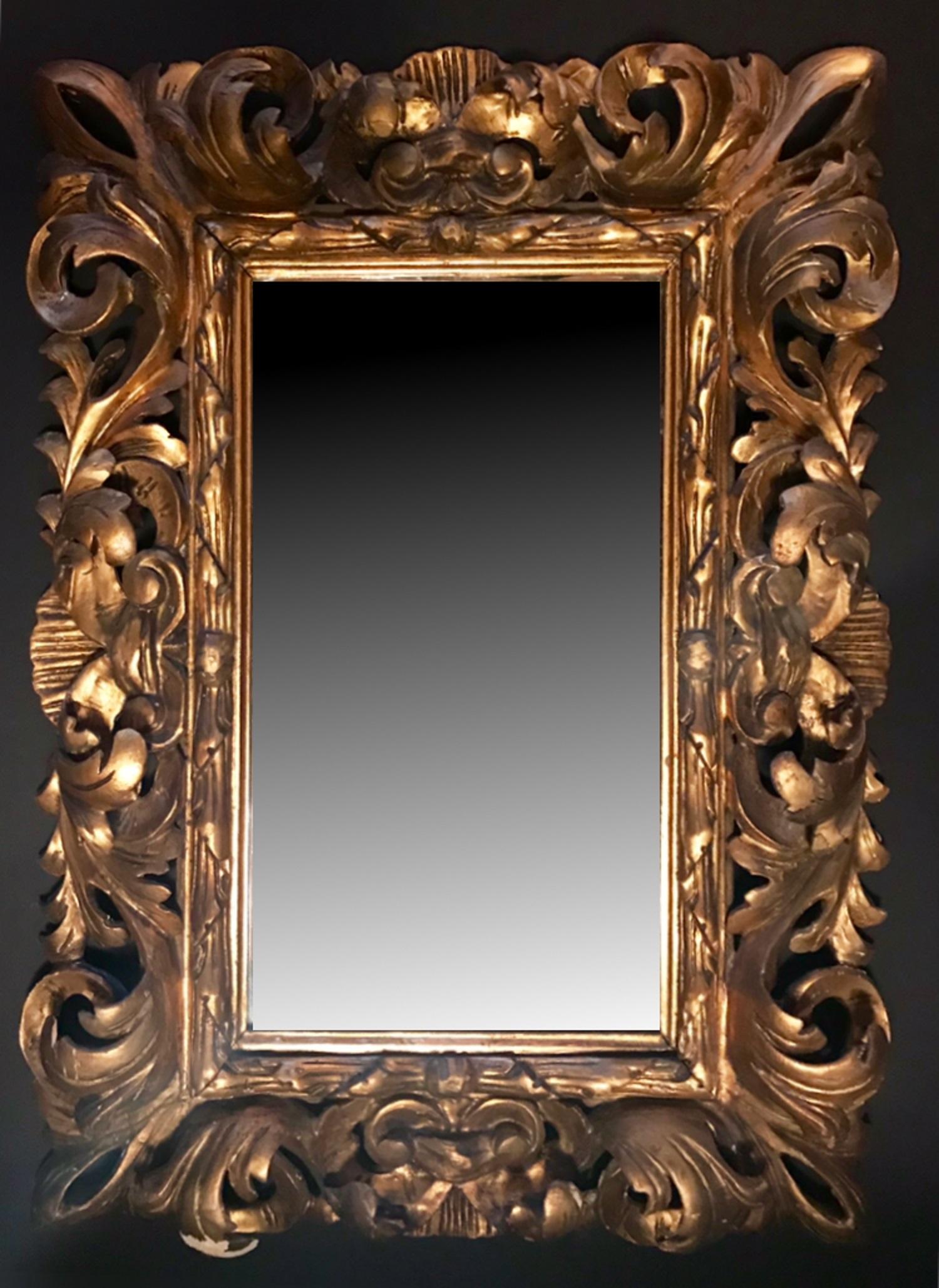This is a beautiful hand carved and gilded mirror frame. It is a dramatic wall hanging with a stunning depth of more than 3 inches. The circa 1880 Baroque style frame was created in Florence, Italy. The gilt is original to the period and has