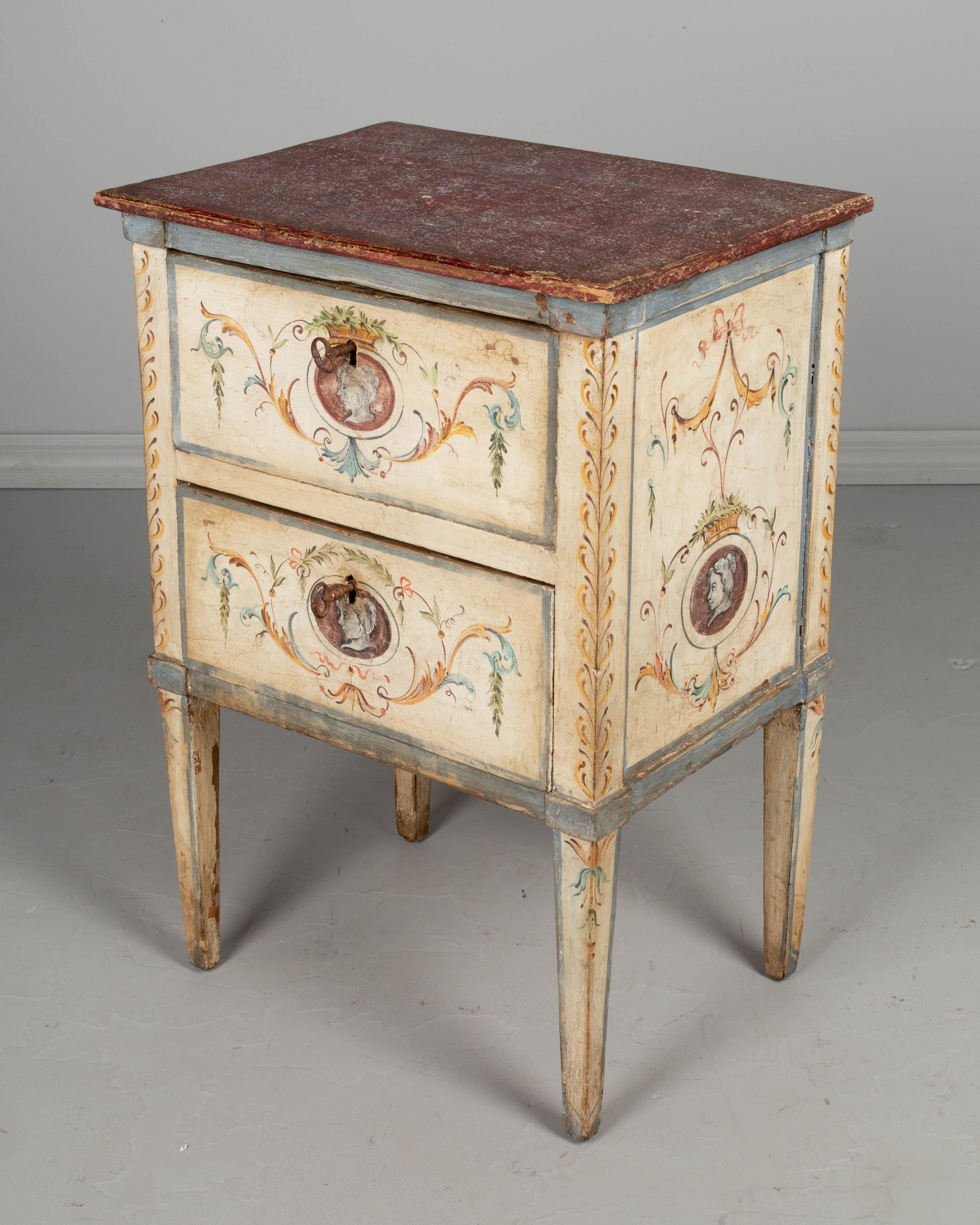 A small Italian Florentine style polychrome paint decorated chest, or nightstand. Made of pine, with two dovetailed drawers. Newer locks are in working condition with two keys. Mid-19th century case with later paint. In good condition, sturdy and