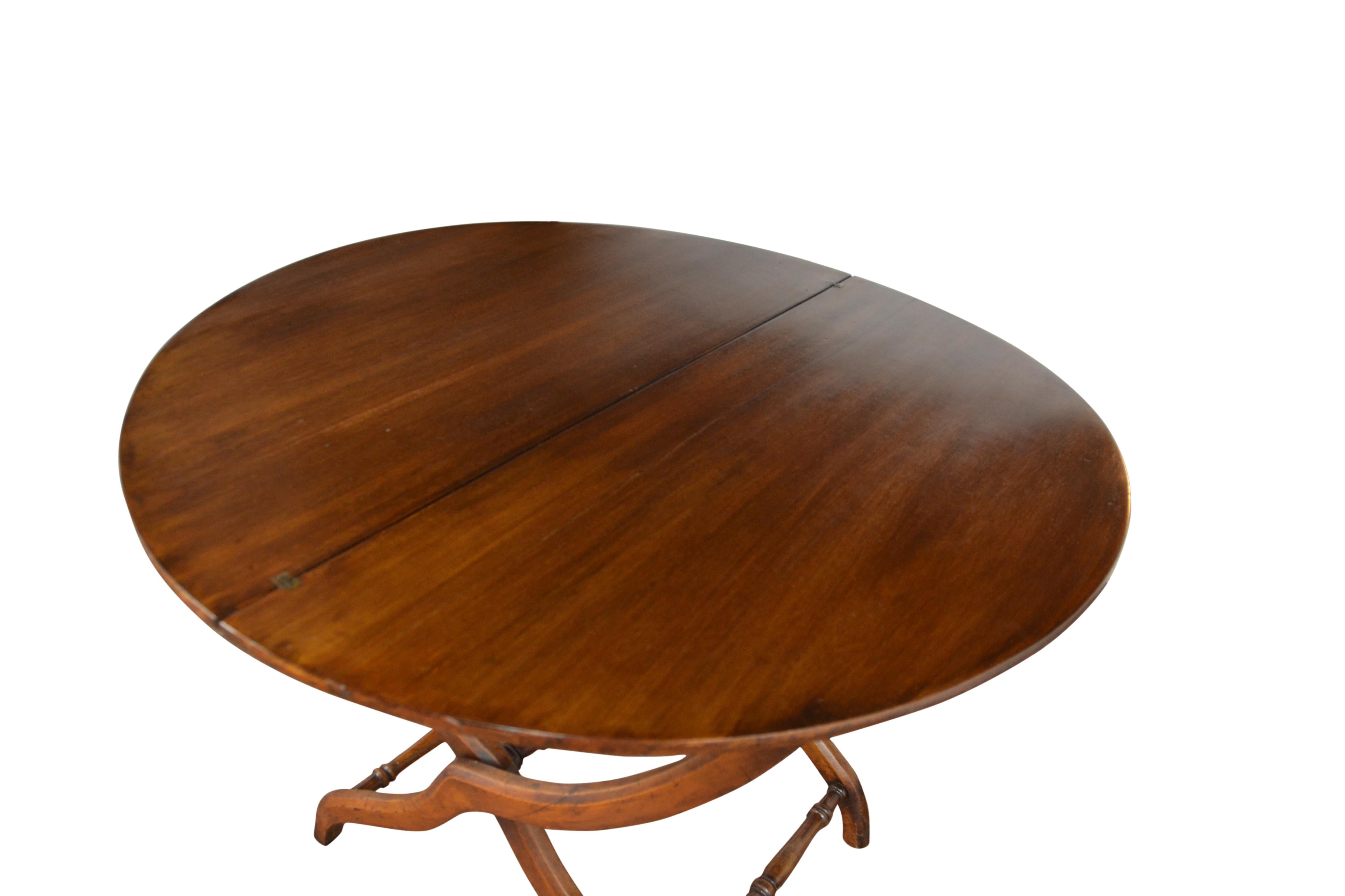 A Campaign style round table with an unusual folding mechanism. Makes a nice smaller size dining table or game table.