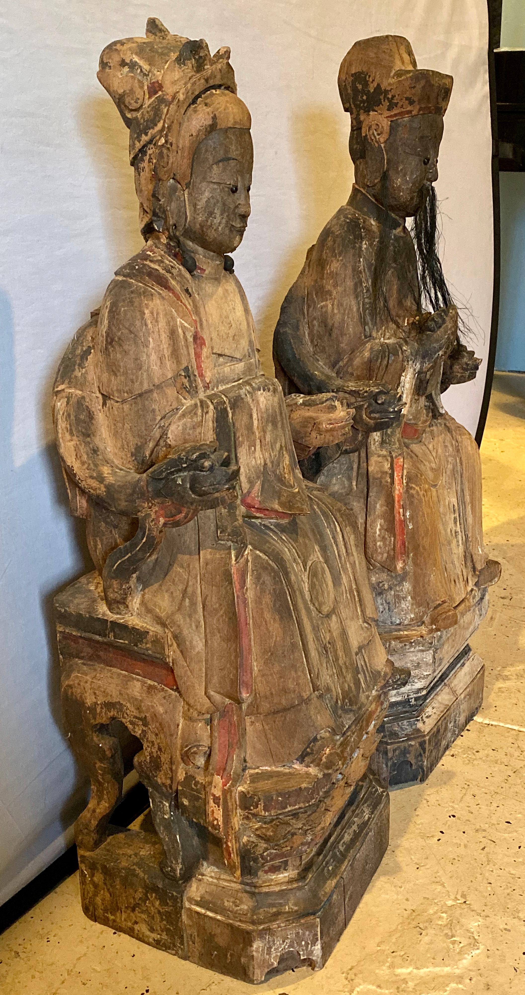 19th century Chinese statues of Emperor and Empress. Solid wood carvings almost life-sized. These stunning Fine examples of Female And Male Chinese solid wood carved statues of the Emperor and Empress are sure to draw plenty of attention in any