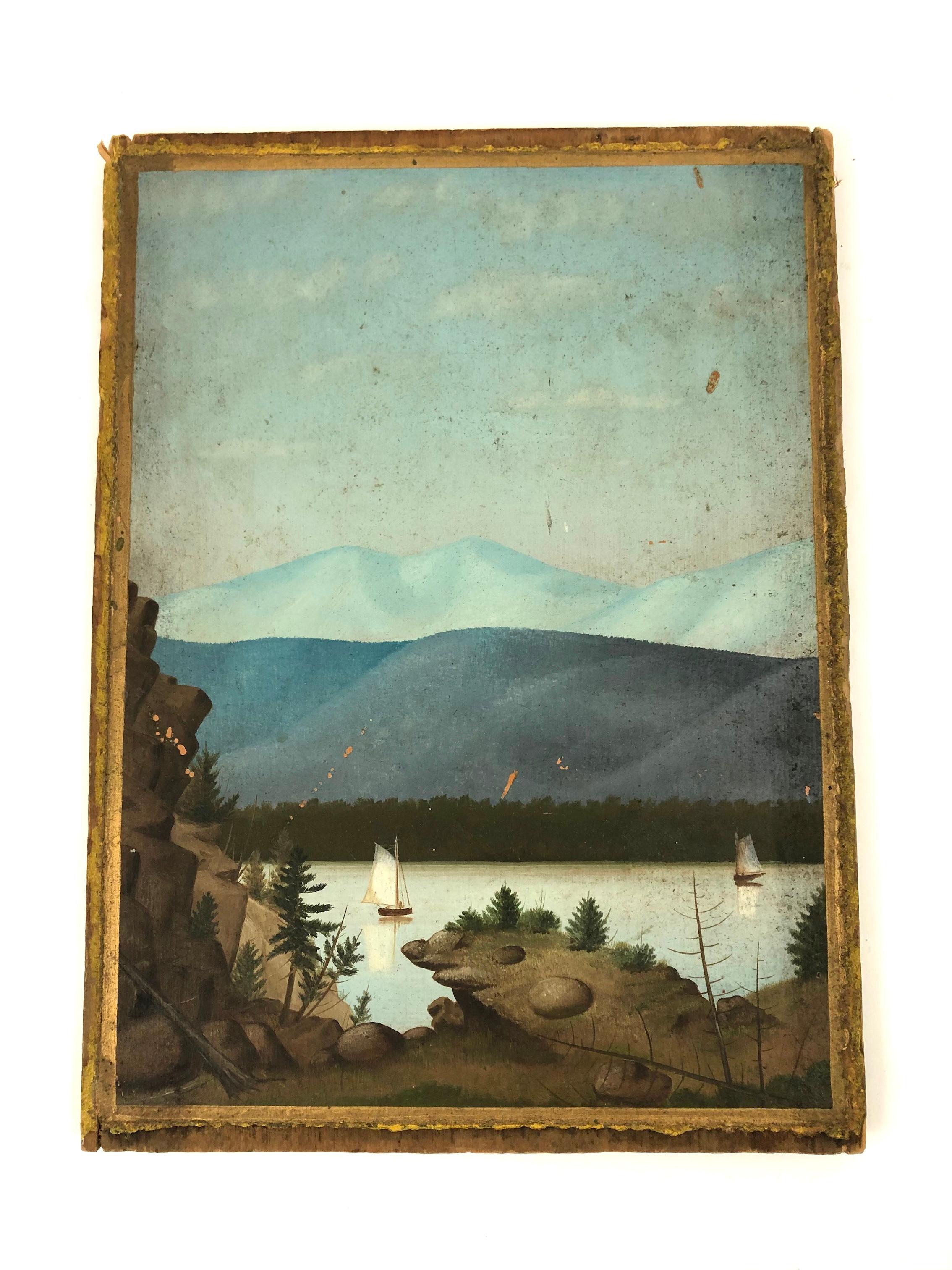 A 19th century American Folk Art double sided landscape painting on wood, depicting sailboats on a lake surrounded by mountains, in beautiful shades of blue, green and brown. The painting was found in Connecticut and, with its beveled edges and two
