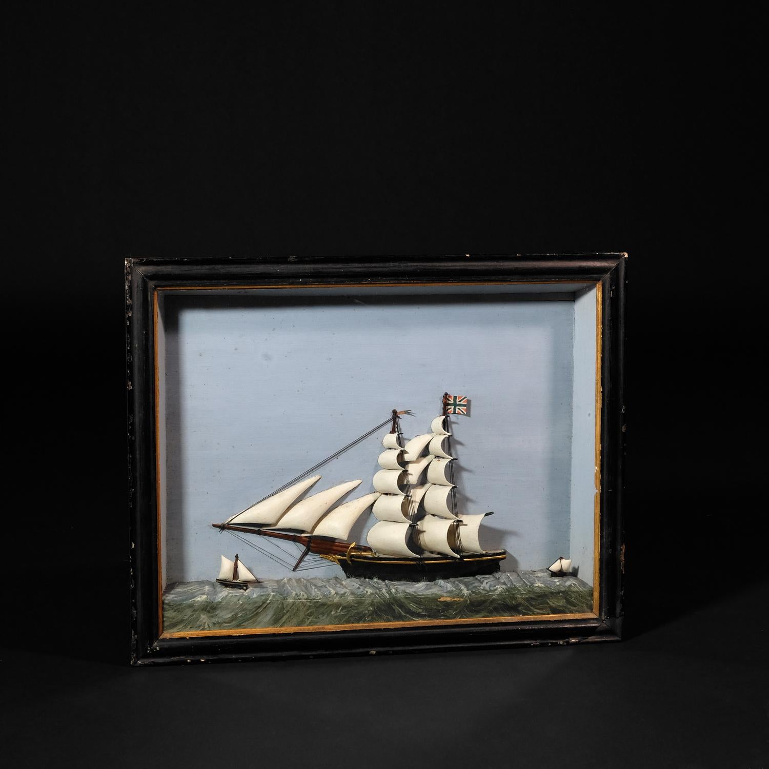 A charming large 19th century diorama of a full sailed brig, flying the union jack and escorted by two smaller vessels. In its original case and glass. Can be hung on the wall.

H: 44cm W: 55cm D: 7cm.