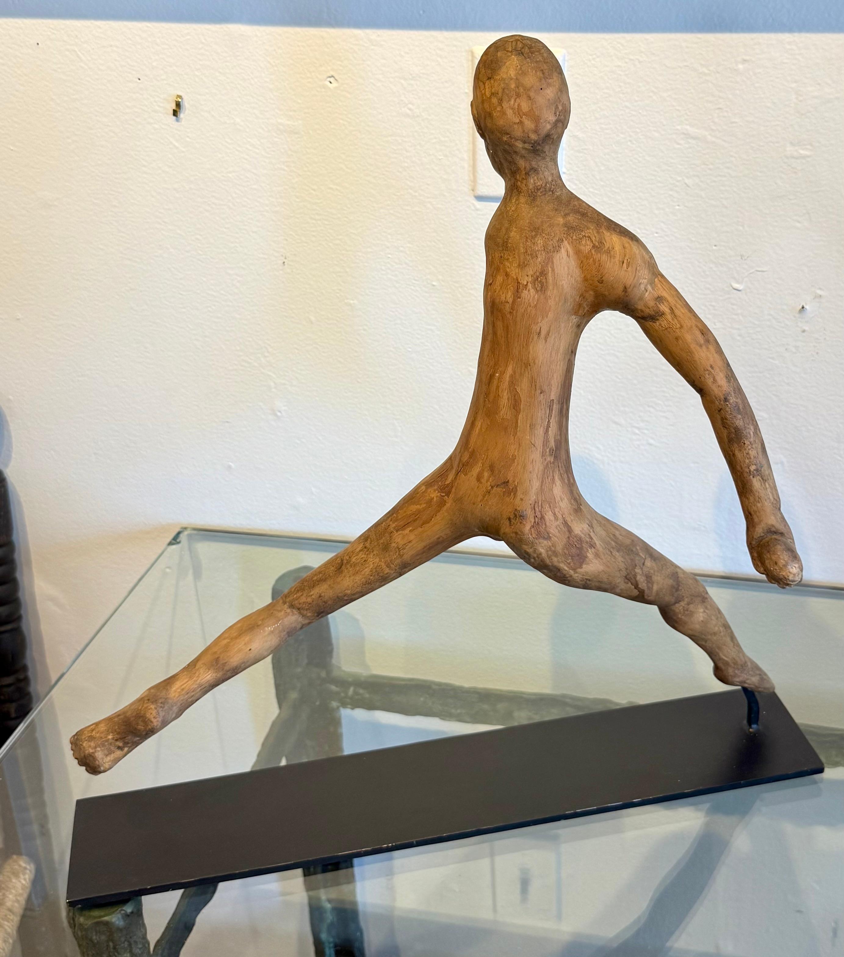19th Century American wood root folk art carving of a man with one arm.  Presented on a custom metal stand.
Measuring 19 .5