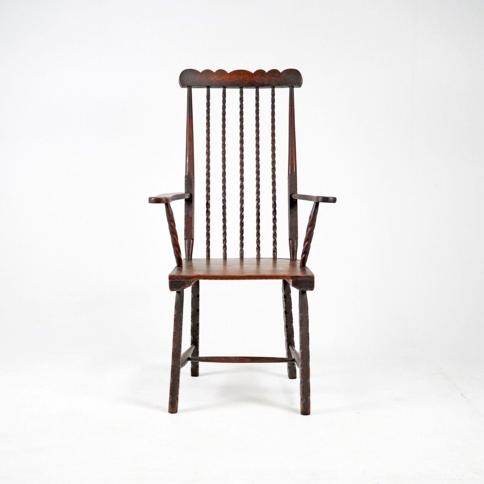 Early 19th century English elm folk art comb back Windsor chair. 
A unique and rare chair with tons of character. 
Barley twist spindles and extensively notched carved on the legs and seat.

Some signs of historic wood worm that has been treated.
