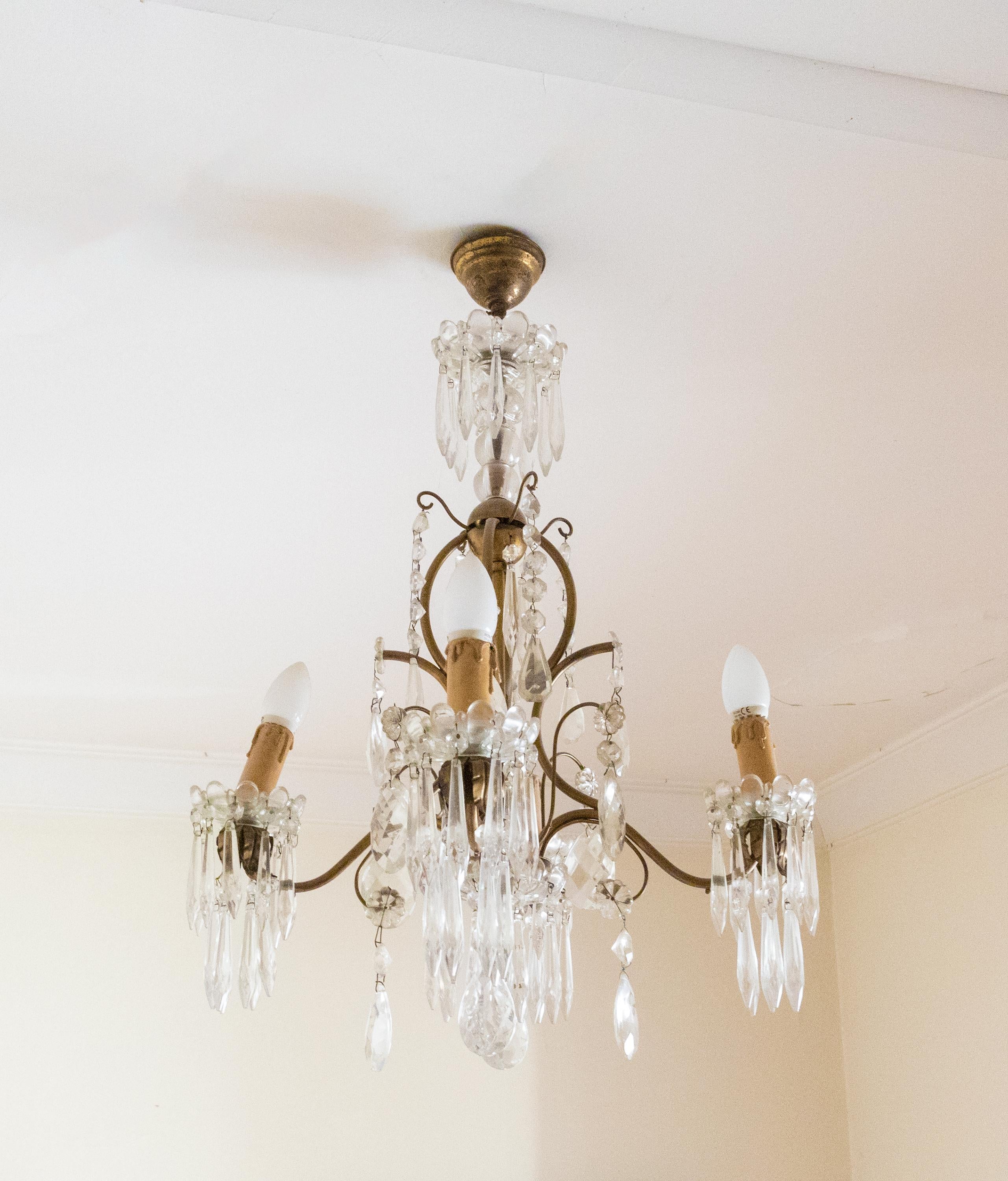A 19th century crystal small chandelier, four arms and four candles,  in the style of Louis XV.
Fully rewired and gilted 

Height 67 cm
Diameter 46 cm 

The chandelier is currently wired for both European Union and US standards LED lights. The LED
