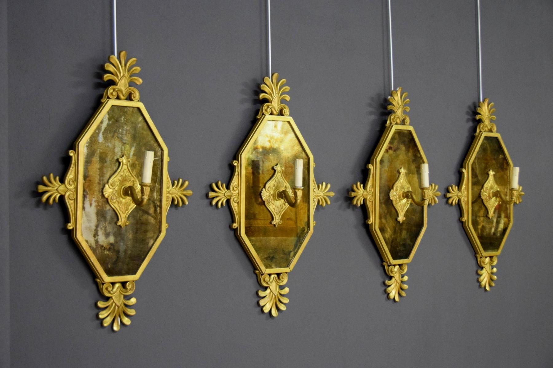 19th century, four Empire style giltwood wall applique

The four delightful carved and gilded wood wall applique are made in Empire style in the end of 19th Century. They have an octagonal, oblong mirror with a simple wood frame decorated, on four