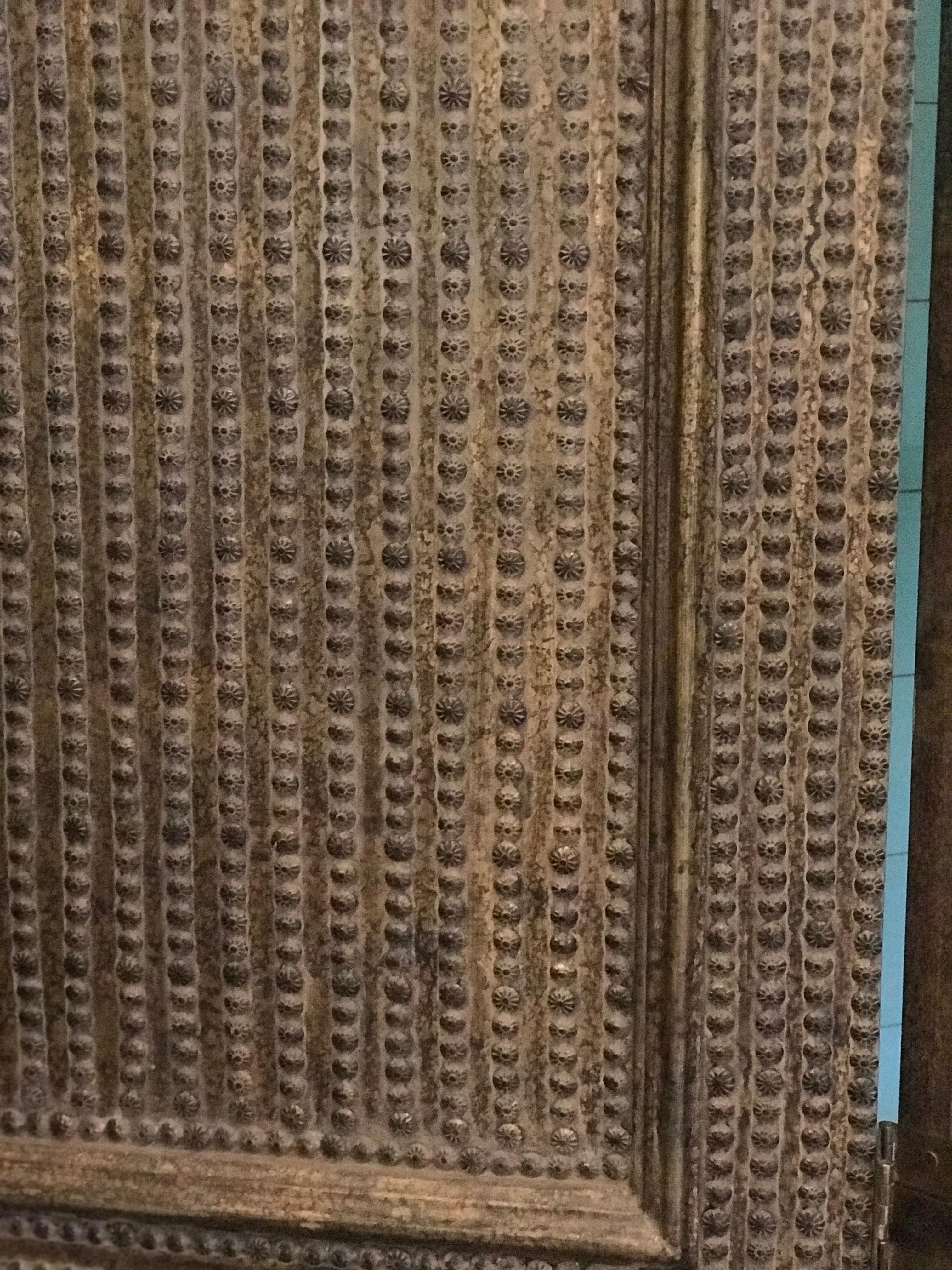 Four-panel folding screen made with brass studs. Each section is divided into two sections. The back of the screen is painted black. It is very well done and it is very heavy in weight.