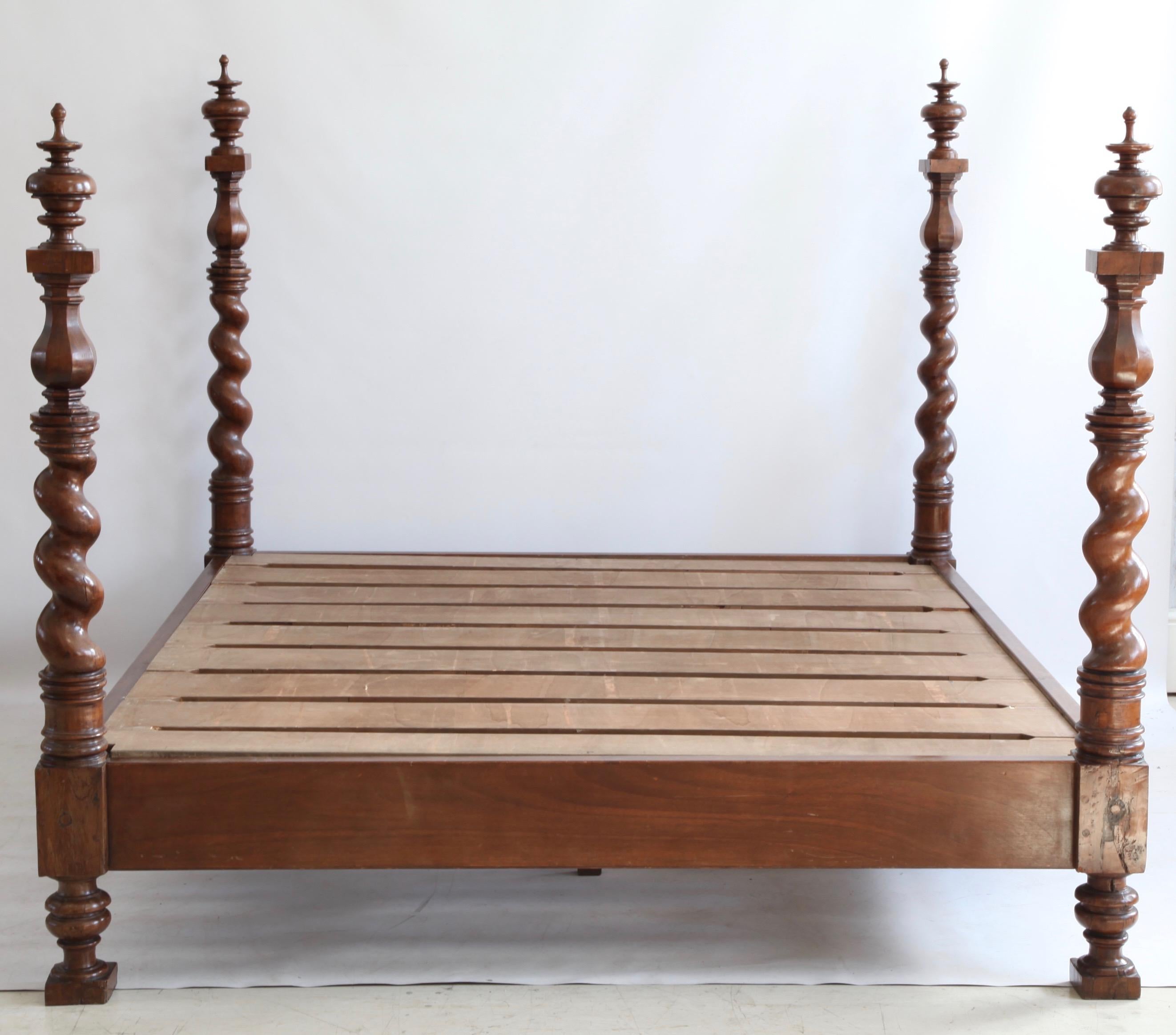 Solid Walnut Italian four poster bed.

The columns seems to be of an earlier period (18th century).
Looks like the bed was made around theses 4 pieces at a later stage.

Measures; Headboard column height 162cm h
footboard column height 150cm