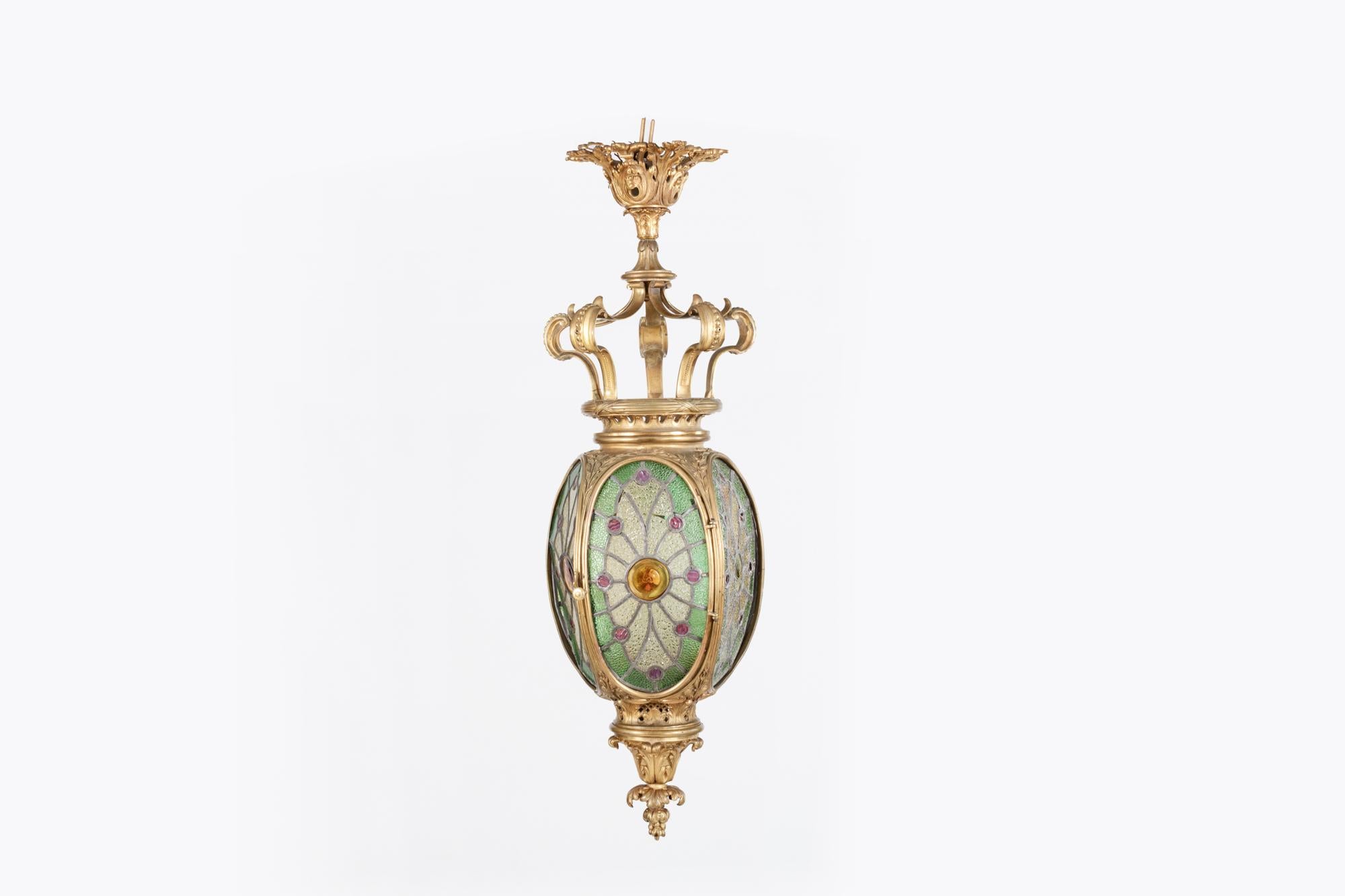 19th Century heavily decorated four-sided brass hall lantern with original stained glass panels.