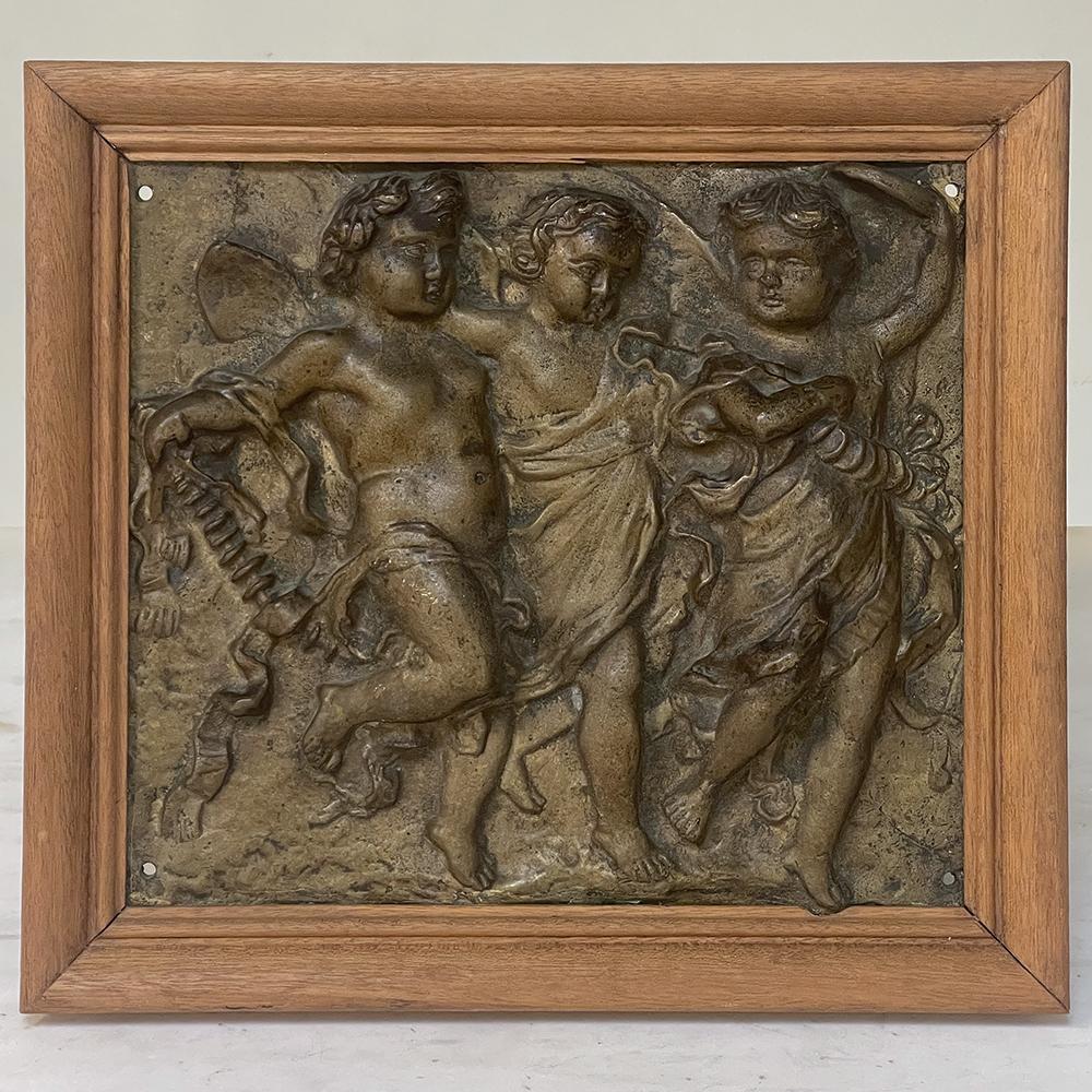 19th Century framed bronze plaque of three cherubs will make a charming neoclassical accent to any room! Cast in solid bronze and given a finish that has achieved a lovely patina over the past 120 years, it depicts three cherubs, with the one on the
