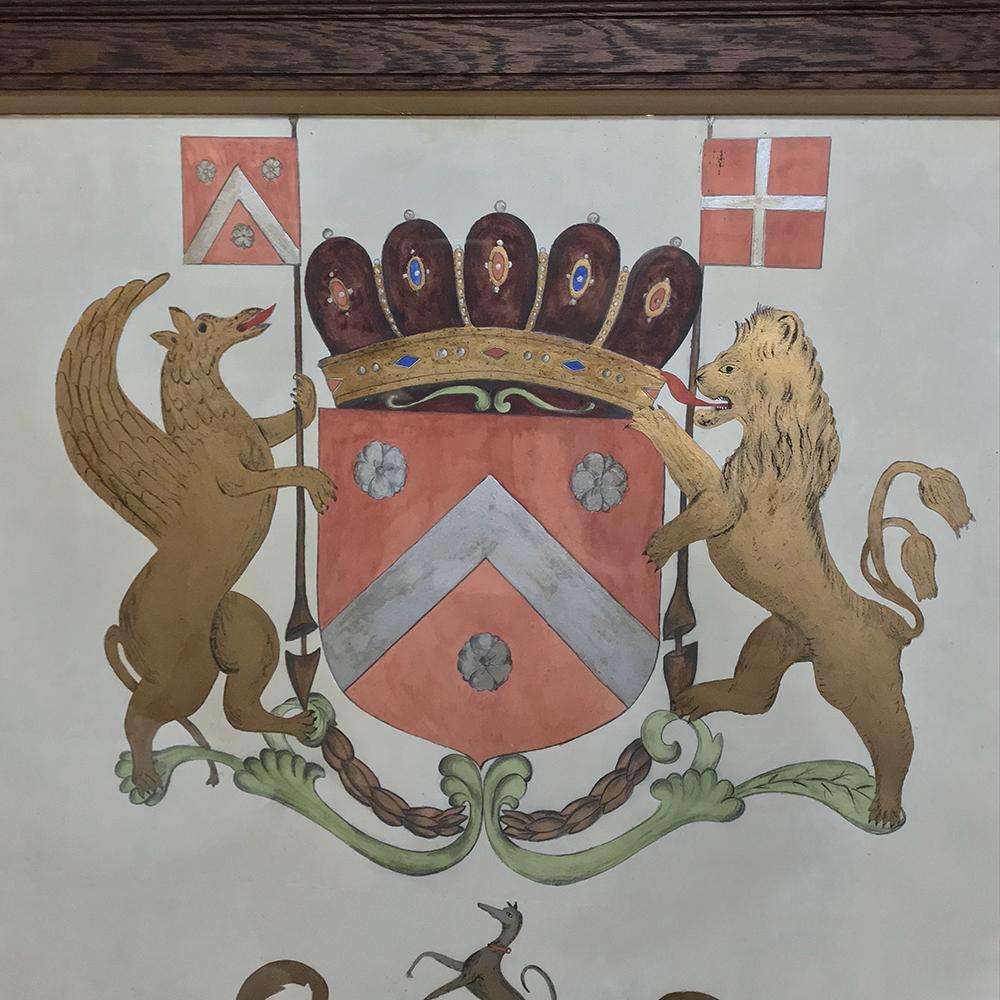 19th century framed painting of family crests was hand-painted in the late 19th century and framed in the 20th century.  The artist used ink and water colors to create the beautiful jewel tone coloration.  The Latin inscription below translates to: