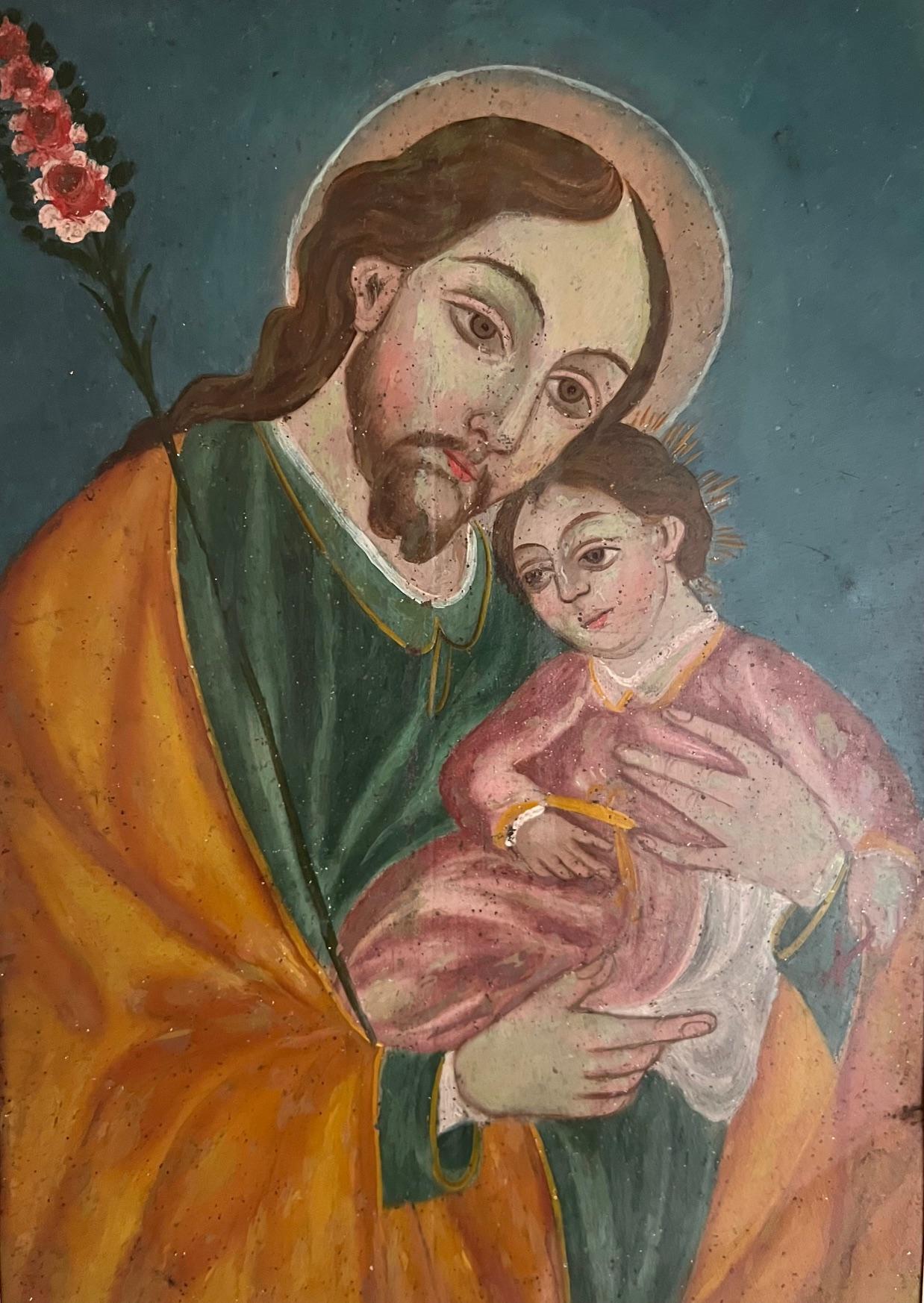 Antique retablo showing Saint Joseph with a child Jesus. Vibrantly painted in rich turquoise and burnt orange colors. Matted in cream and velvet in a vintage wood frame.

Retablo measures about 12.5 x 9.5

Saint Joseph is well known as the patron