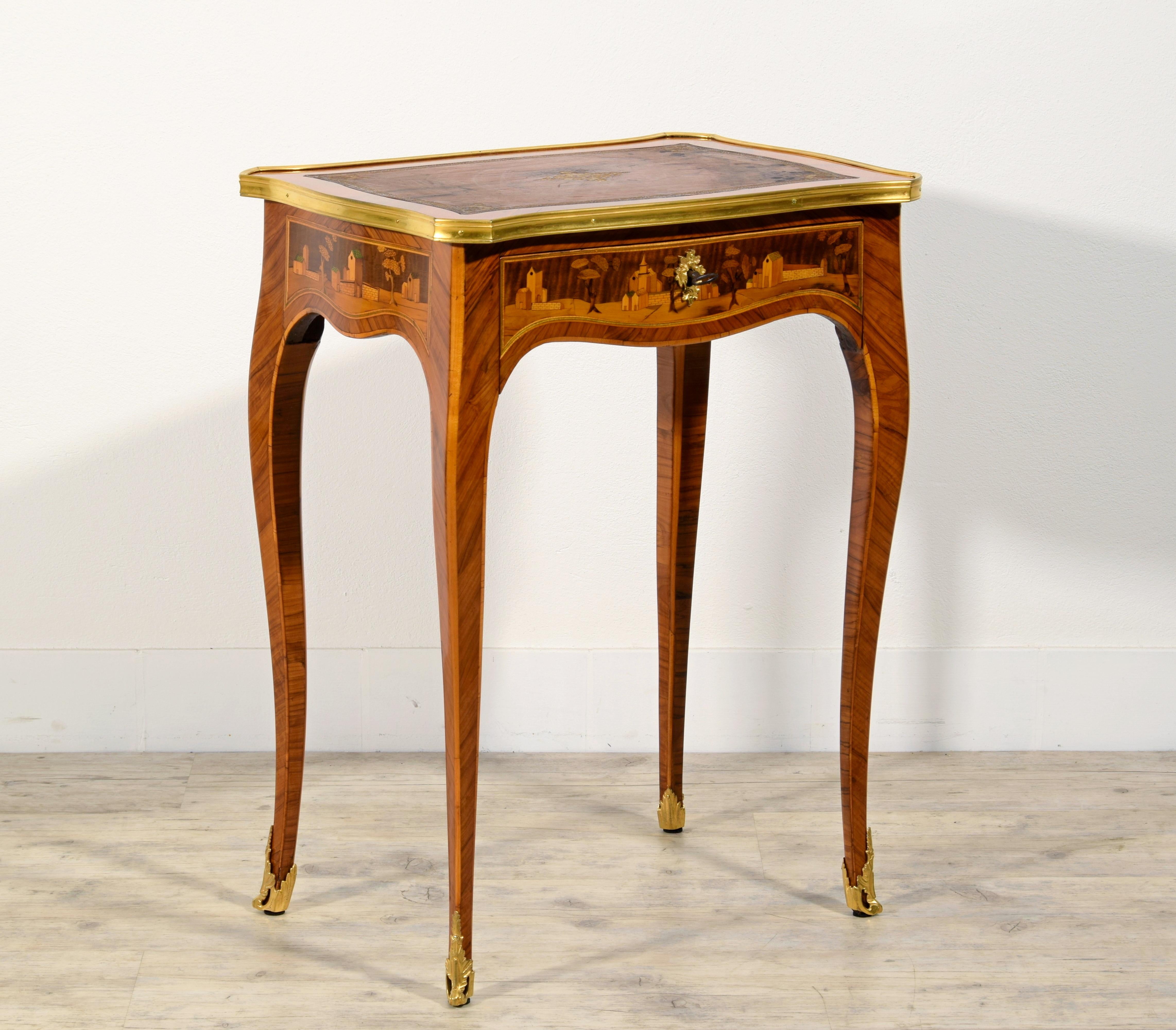 19th Century, France inlaid wood centre table 

This elegant centre table in inlaid wood was made in France in the early 19th century.
The rectangular top has shaped and wavy sides bordered by a gilded bronze lingotière. Veneered in wood,