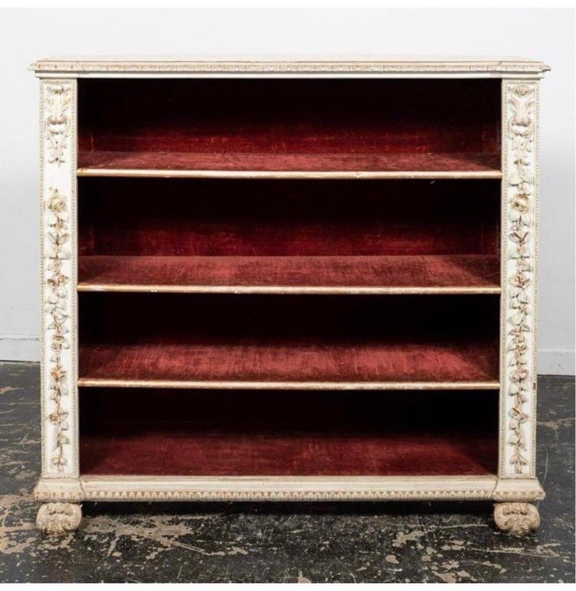 Francesco Somasca (Italian,19th century), last quarter 19th century. Cream painted and carved wooden bookcase in the baroque taste having and overhanging acanthus edge top supported by floral decoration, velvet lined interior with threeshelves,