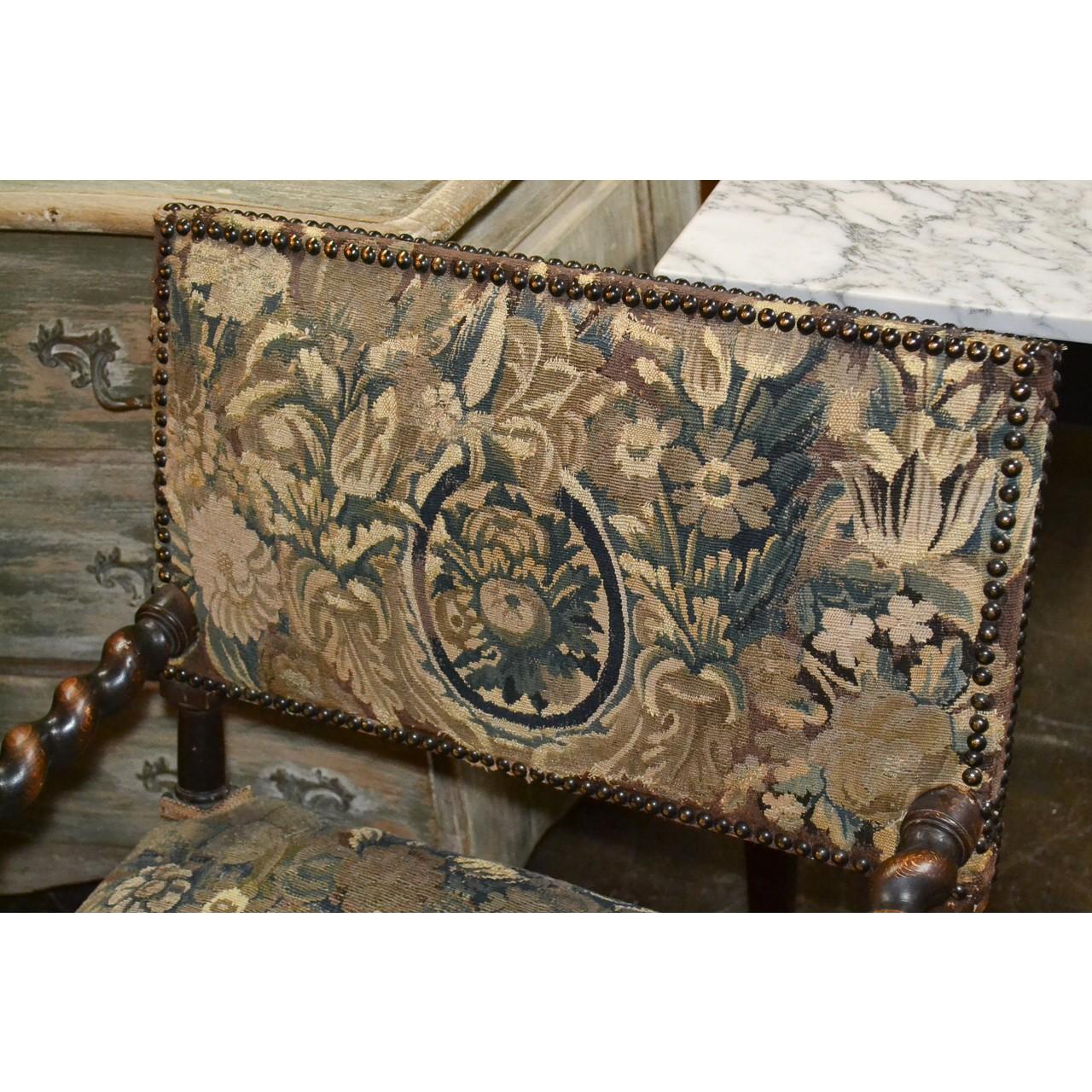 Rare 19th century Franco Flemish baroque carved walnut armchair with fine verdure tapestry upholstery accented with brass tacking. Barley twist frame and stretcher with unique figural carvings at the arms of superb detail,

circa 1890.