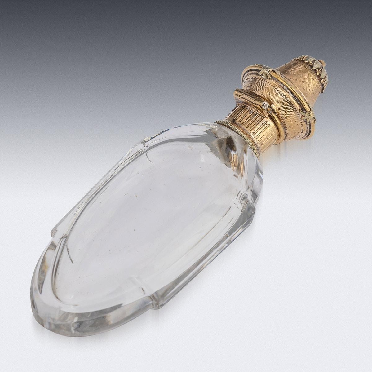 Antique mid-19th Century French 18k gold mounted perfume bottle, lozenge shaped glass body set with a gold collar and hinged lid engraved with engine turning and scrolling foliage. Apparently unmarked (tested 750 standard, used 1838 - present),