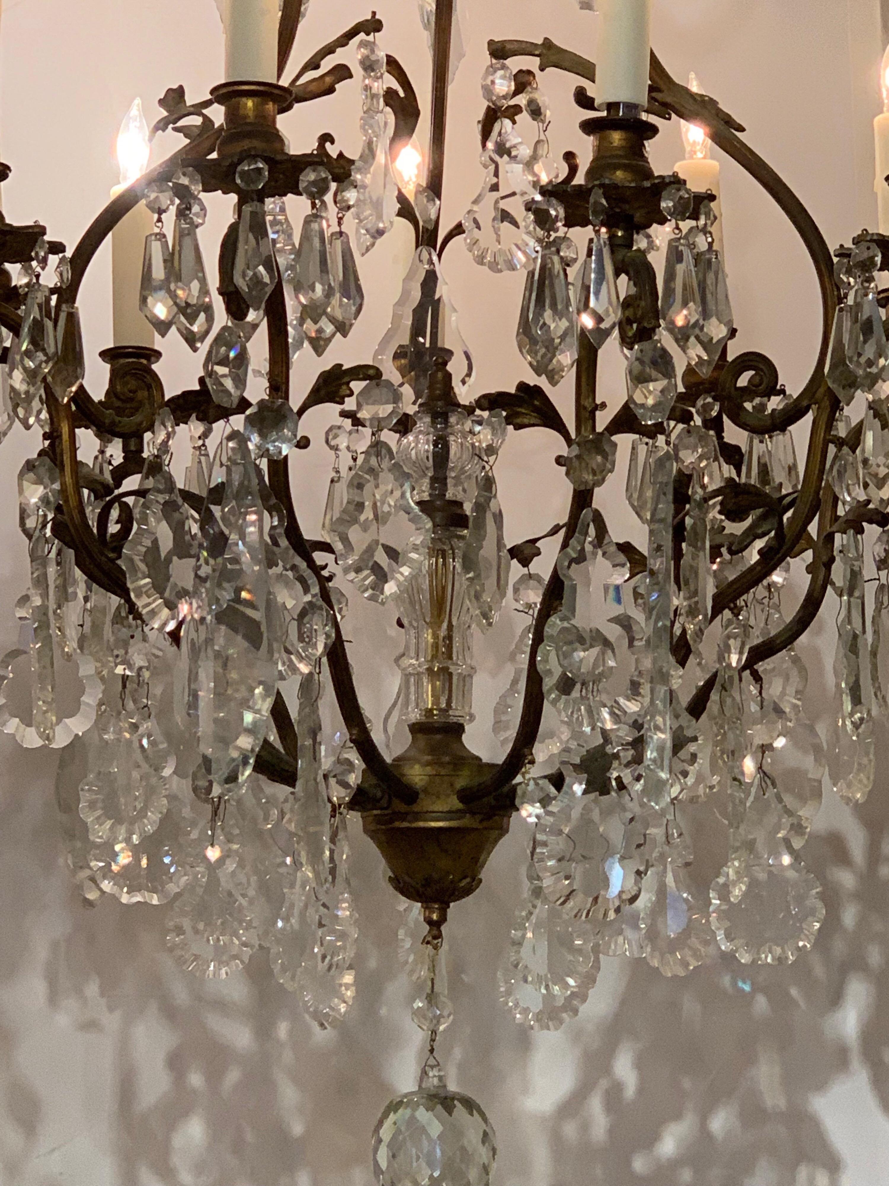 19th century French bronze crystal chandelier. Multiple large cut crystals on a lovely bronze frame. Very elegant! Just re-wired, cleaned and ready to hang. Matching chain and canoy provided with all of our chandeliers.
