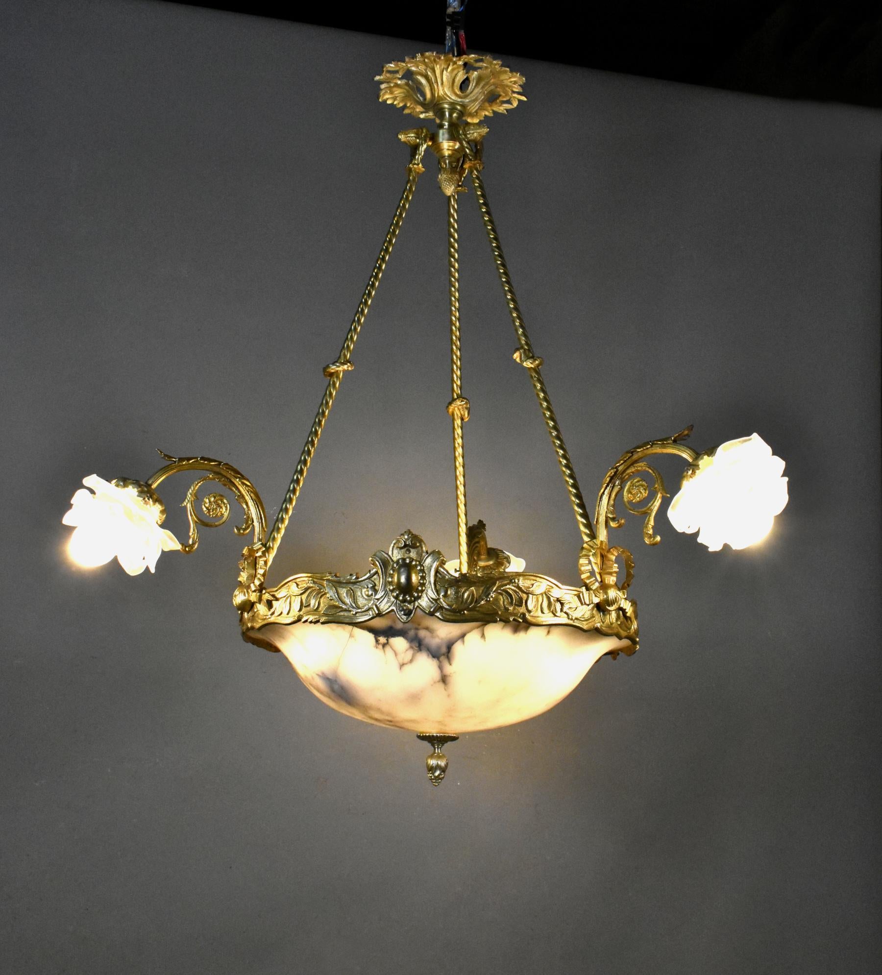 French Antique Bronze & Marble Alabaster Chandelier (1890) Napoleon III 

This large and impressive bronze chandelier stems from an acanthus leaf ceiling rose via three twisted bronze arms to its main central decorative crown. 

The crown is