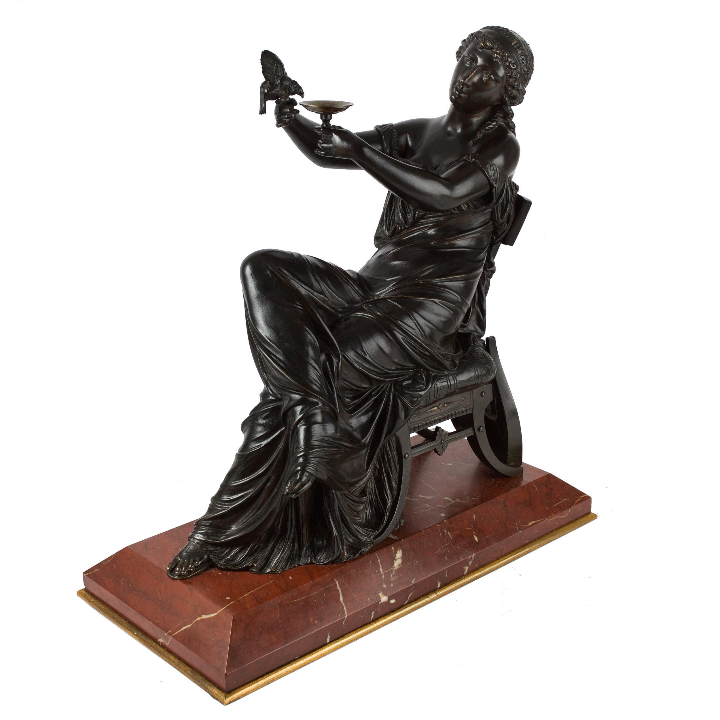 A fine sand-cast model of a seated figure of Sappho circa the third quarter of the 19th century, she is an attractive composition featuring a Neo-Greco overall inspiration with a classical garment draped with endless folds over her lounging figure;