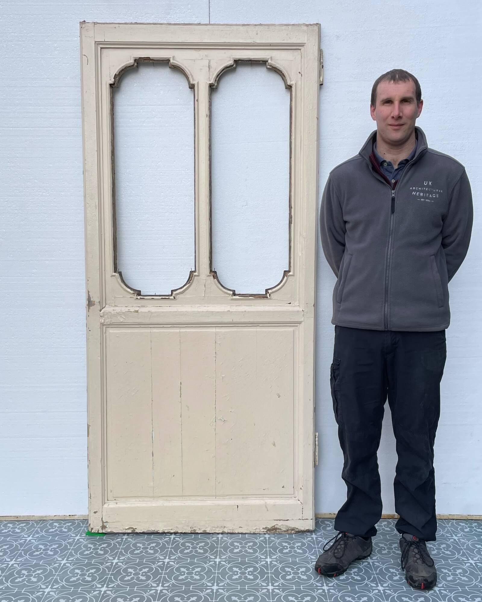You can imagine this unglazed French antique interior door circa 1850 at the entrance to a beautiful French style country sunroom or in a kitchen, leading to a spacious and well-stocked pantry. It is robustly constructed in pine with a distressed