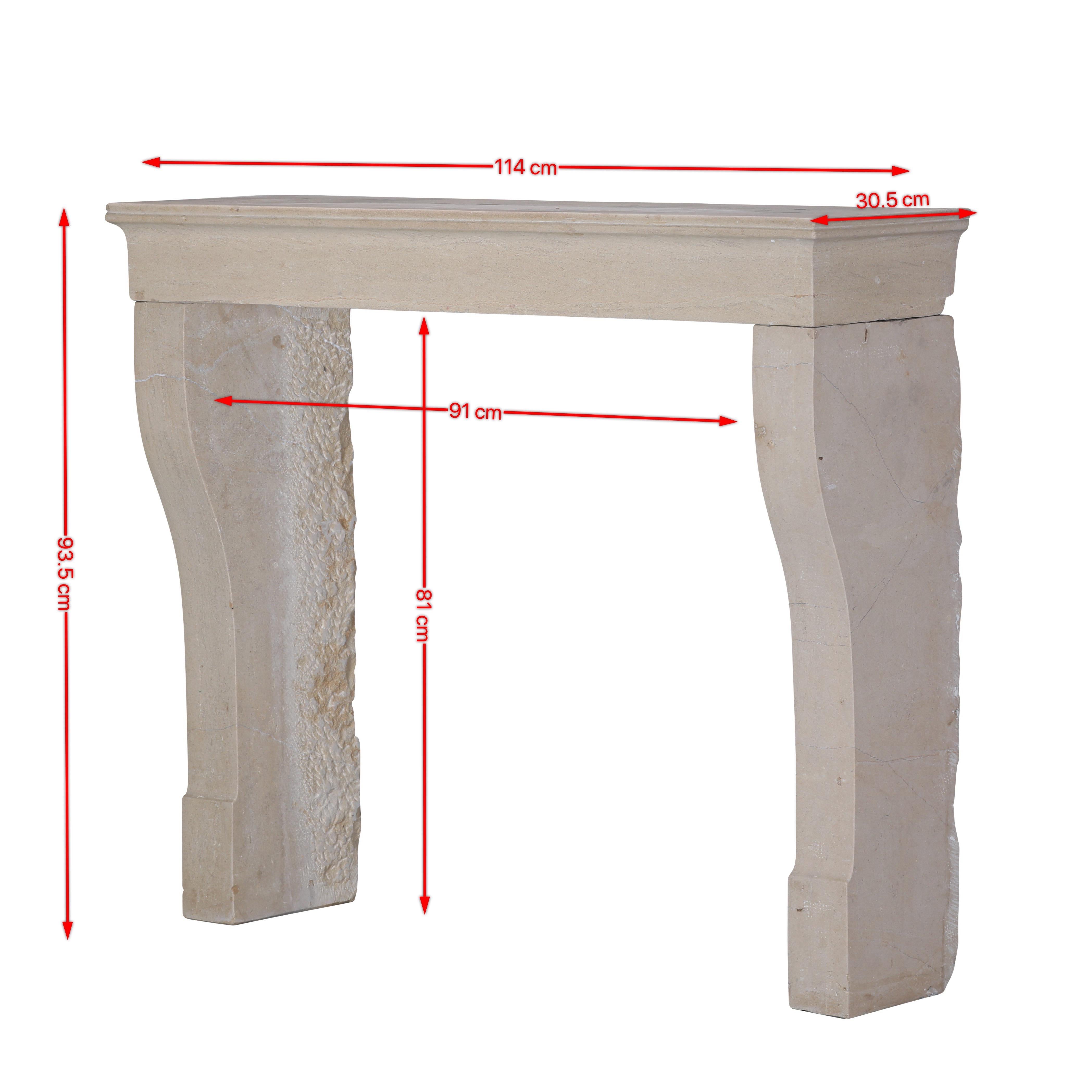 This elegant 19th century French antique fireplace surround is carved from authentic beige limestone, a natural material known for its timeless beauty and durability. Its refined simplicity and uniform off-white tone make it a versatile piece that