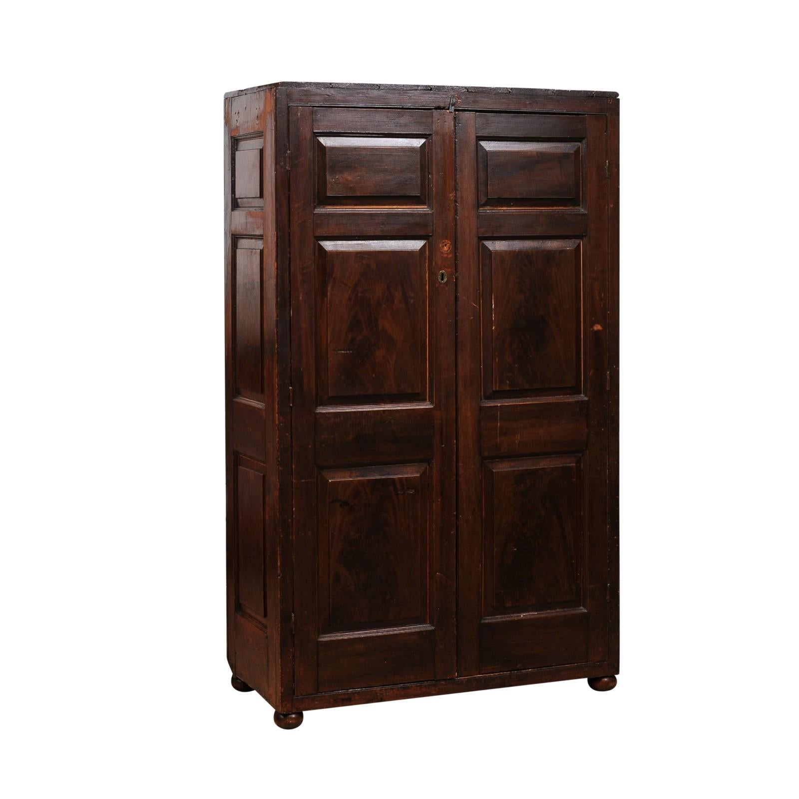This 19th-century antique French pine armoire combines rustic charm with practical storage solutions, showcasing the craftsmanship and timeless appeal characteristic of traditional French provincial furniture. Crafted in solid pine, the piece boasts