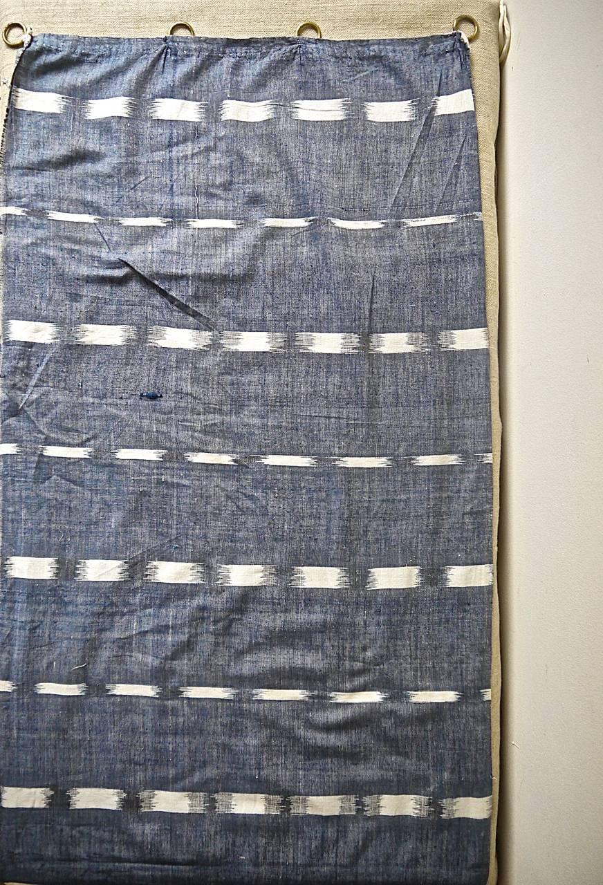 19th century French woven cotton flamme/ikat panel with its original brass curtain rings.A lightweight cloth.