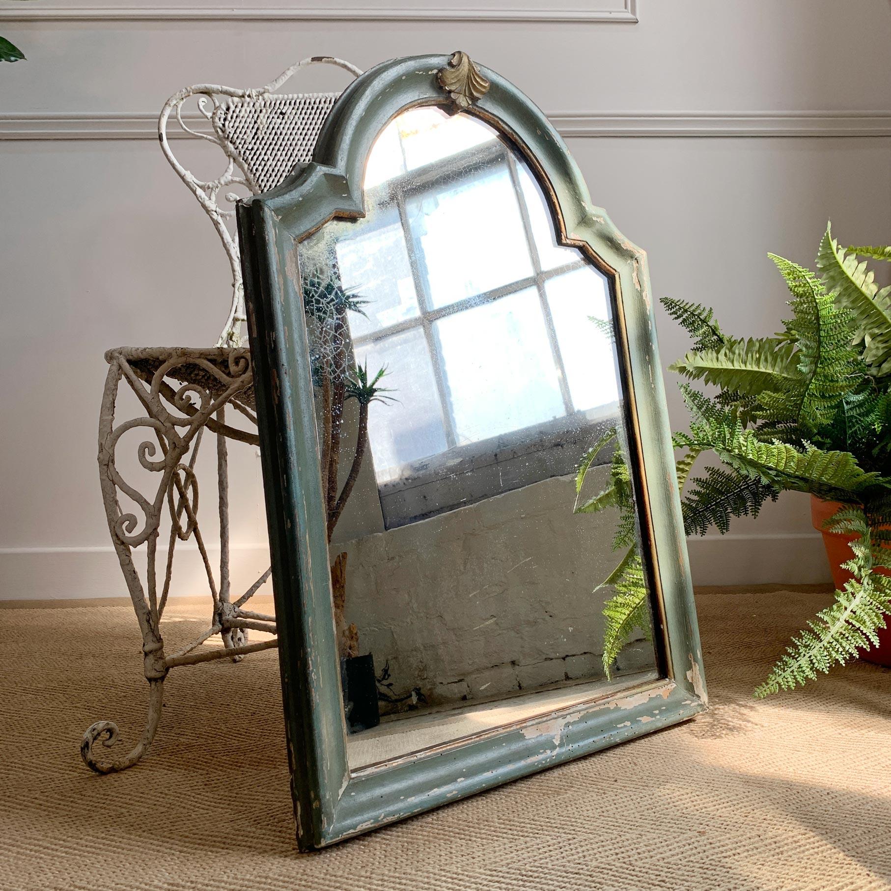 A beautiful 19th century French arch top mercury plate mirror, gesso over wood, then finished in a deep duck egg green with a gilt leaf decorative element and gilt banding to the interior of the frame.

The mercury plate has wonderful foxing with a