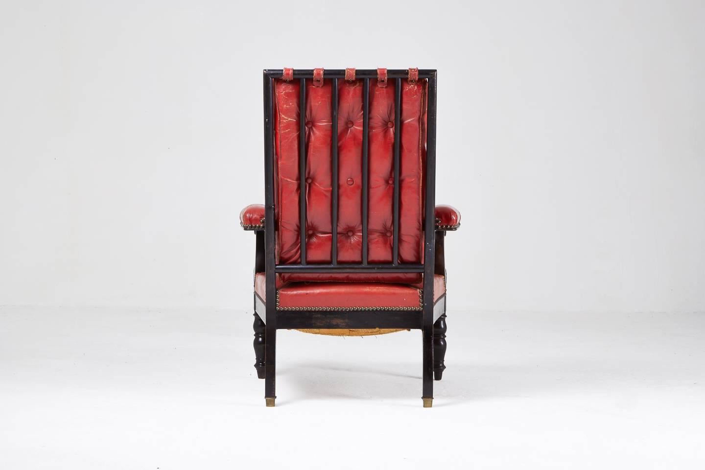 A 19th century French ebonized armchair in old red leather.

 