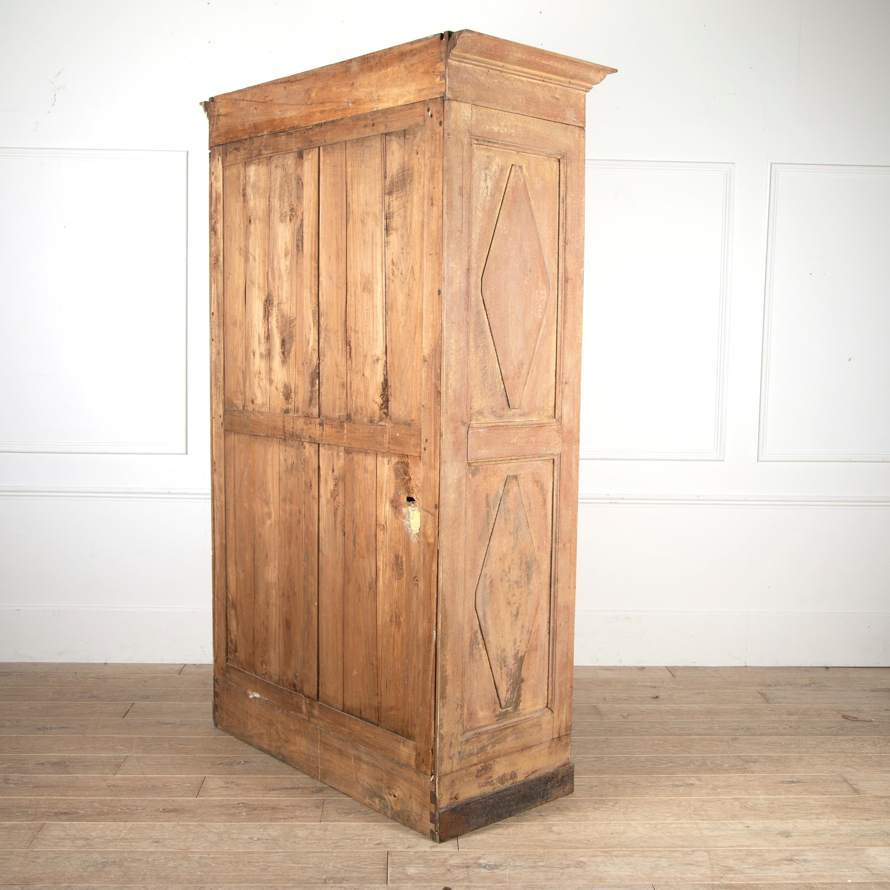 19th Century french armoire in old paint.

This fantastic piece retains its original chest of drawers encased within two paneled doors. The chest of drawers opens to reveal great storage for linen or clothing but also could be converted into