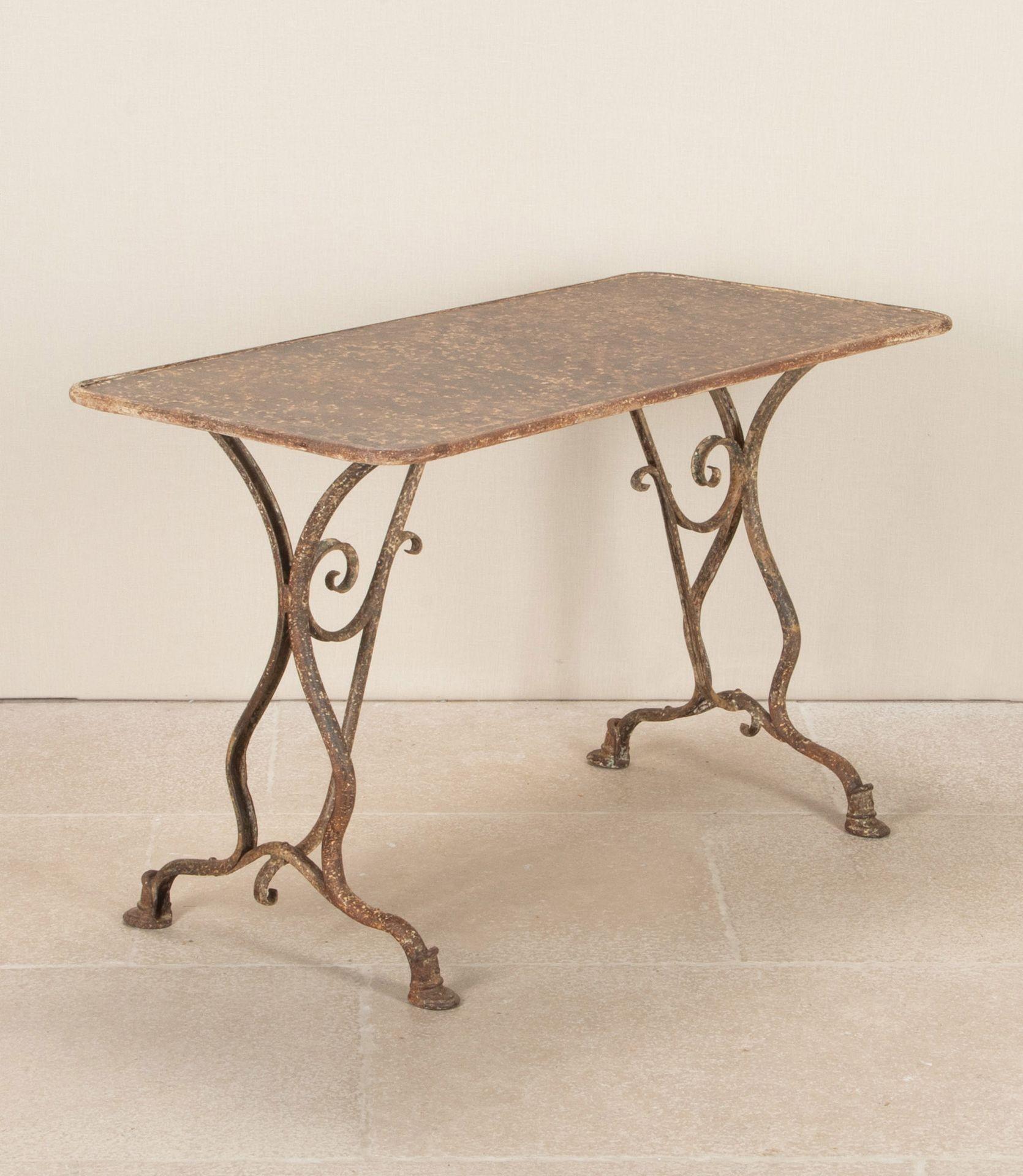 19th Century French Arras iron table. With decorative scrolling and a weathered patina