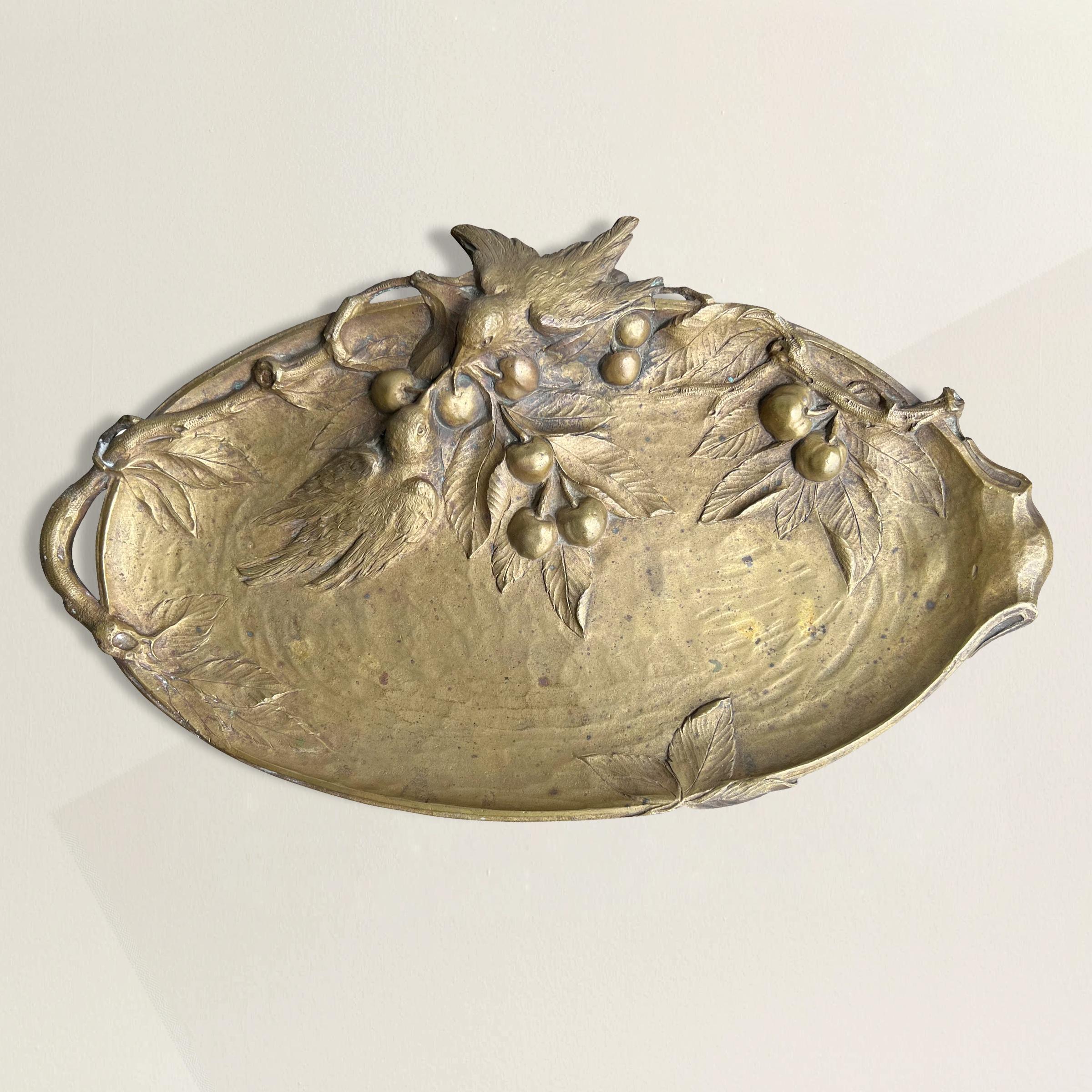 Indulge in the enchanting world of the late 19th century with our mesmerizing French Art Nouveau cast bronze tray. A sublime ode to the ephemeral beauty of youth and innocence, this tray boasts an asymmetrical composition, adorned with a delicate