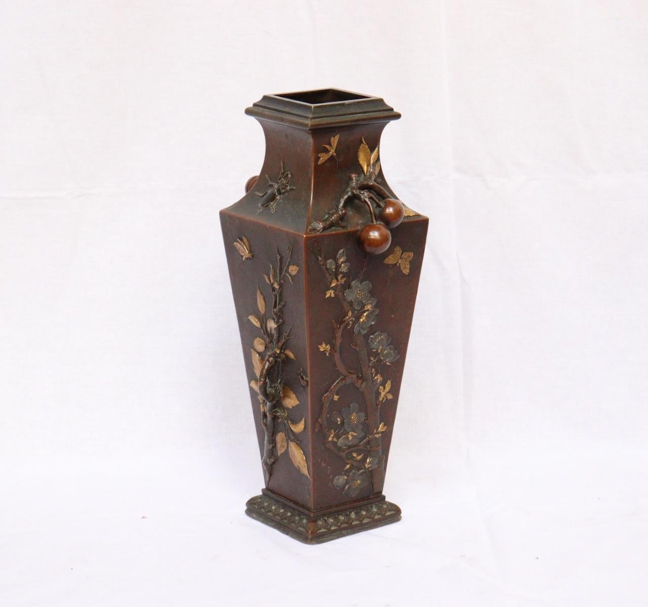 A French Japonisme bronze vase by Léopold Oudry, circa 1870
Bronze square-section baluster vase with brown and gold patina
Relief decoration inspired by Japanese foliage, branches, and insects the handles in the shape of khakis retained by a