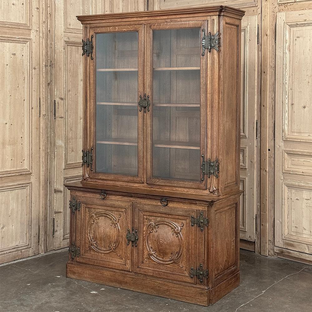 19th Century French Art Nouveau Period Bookcase shows an intriguing touch of flair that foretells the more enthusiastic stylings yet to come.  The interesting roundel on each cabinet door is created with relief molding with a stylized foliate motif,
