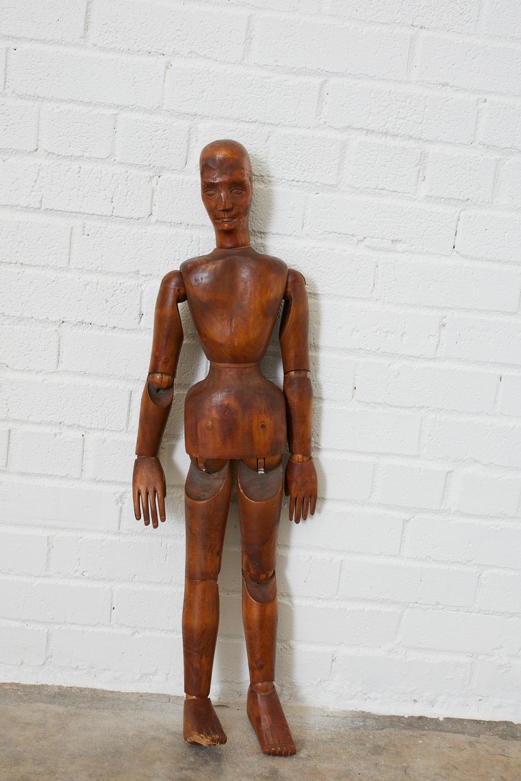 Large 19th century French artists mannequin handcrafted from beechwood. Features articulated joints and wood peg joinery. Beautifully carved face and intricate features. Lovely aged patina on the wood.