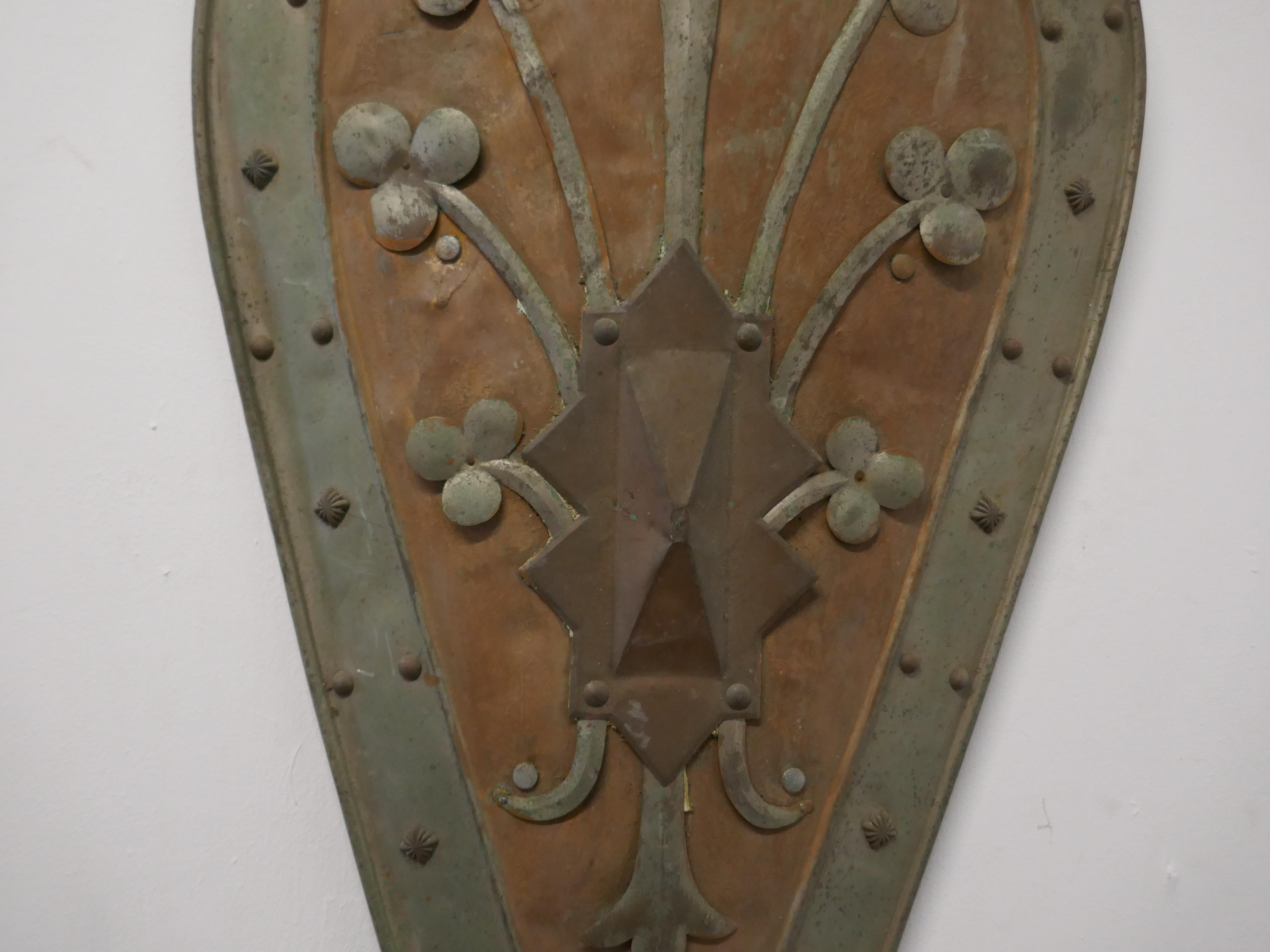 19th century French Arts & Crafts handmade kite shield

An unusual piece made in France in the Arts & Crafts style, can be wall hung, the shield is curved and Kite Shaped, it is decorated with fleurs-de-lis and has iron studs in the border
The